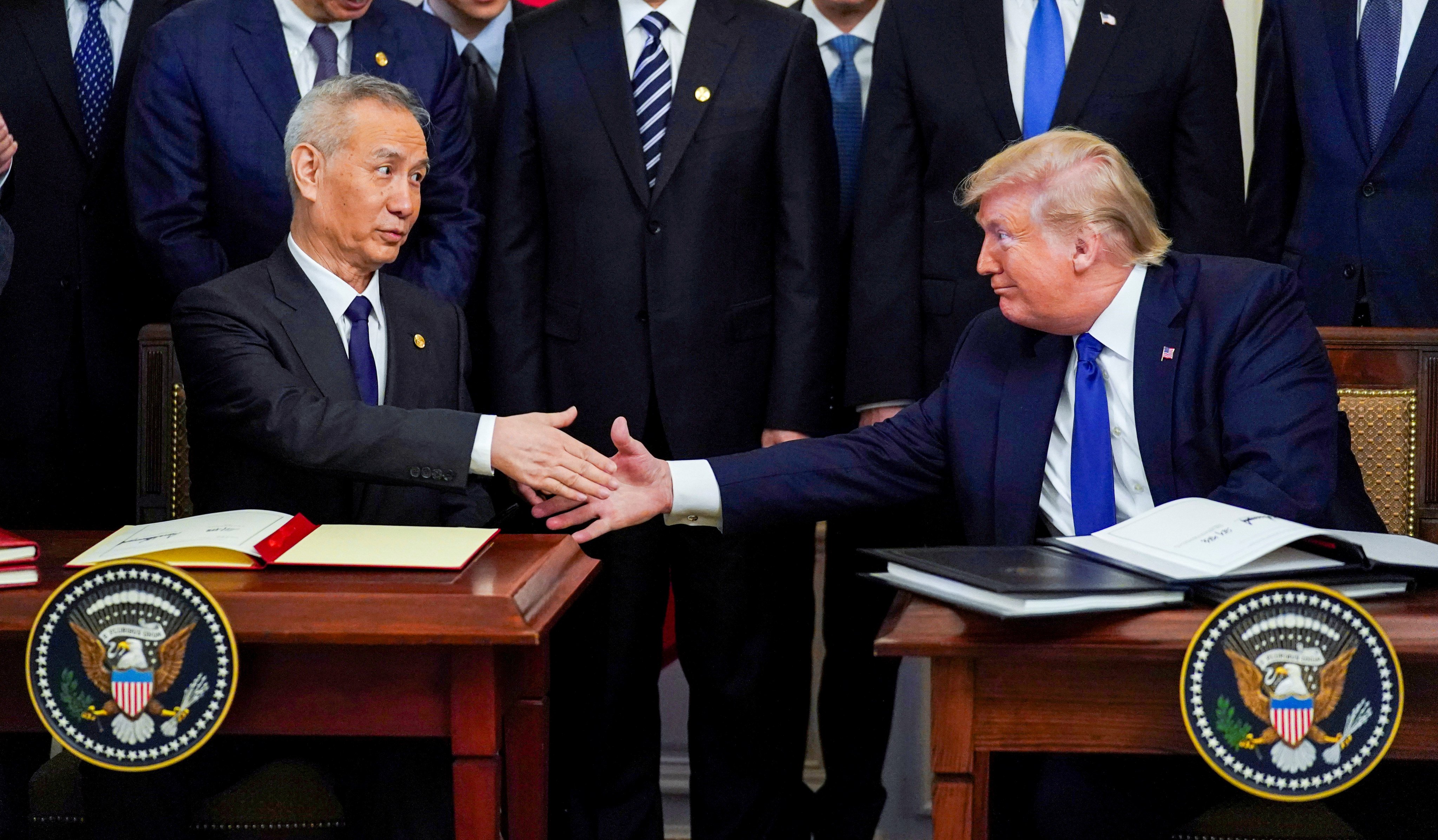 US President Donald Trump and former Chinese vice-premier Liu He shake hands after signing the phase-one trade deal at the White House in 2020. A review of the deal during Trump’s second term may put pressure on China to fulfil its missed requirements. Photo: Reuters