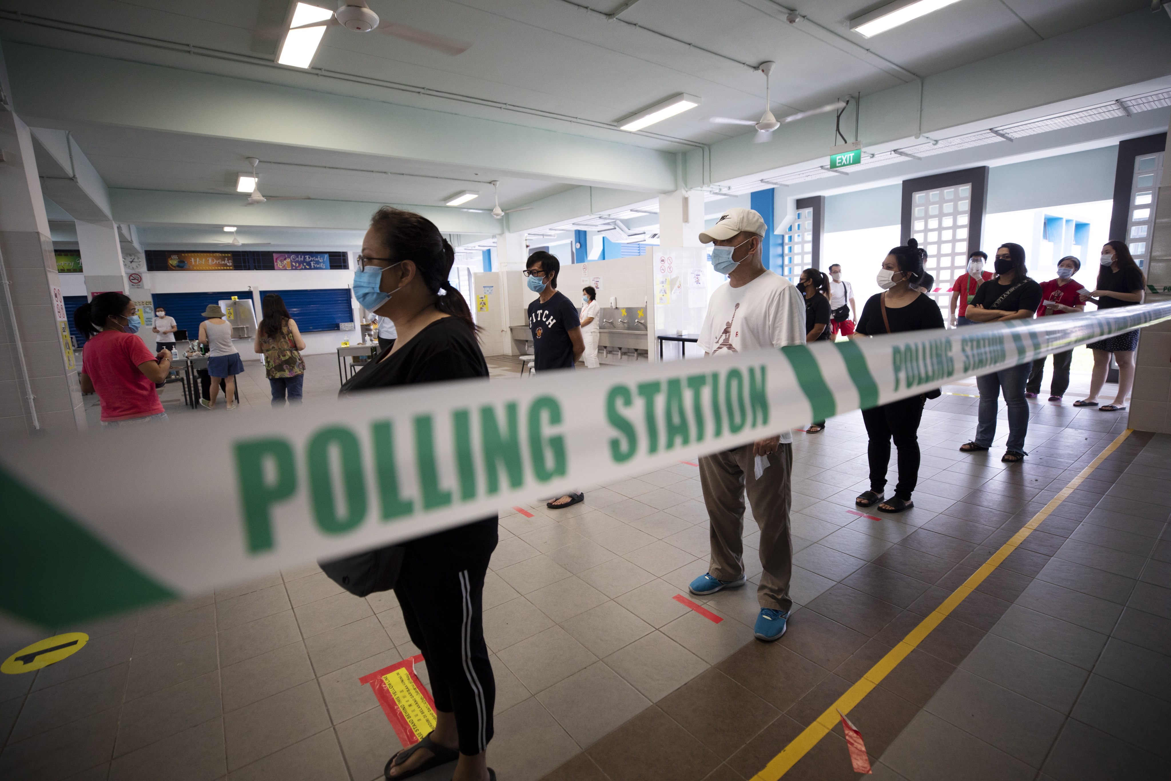 Voters in Singapore queue to cast their ballots at a polling station during the general election on July 10, 2020. Photo: EPA-EFE