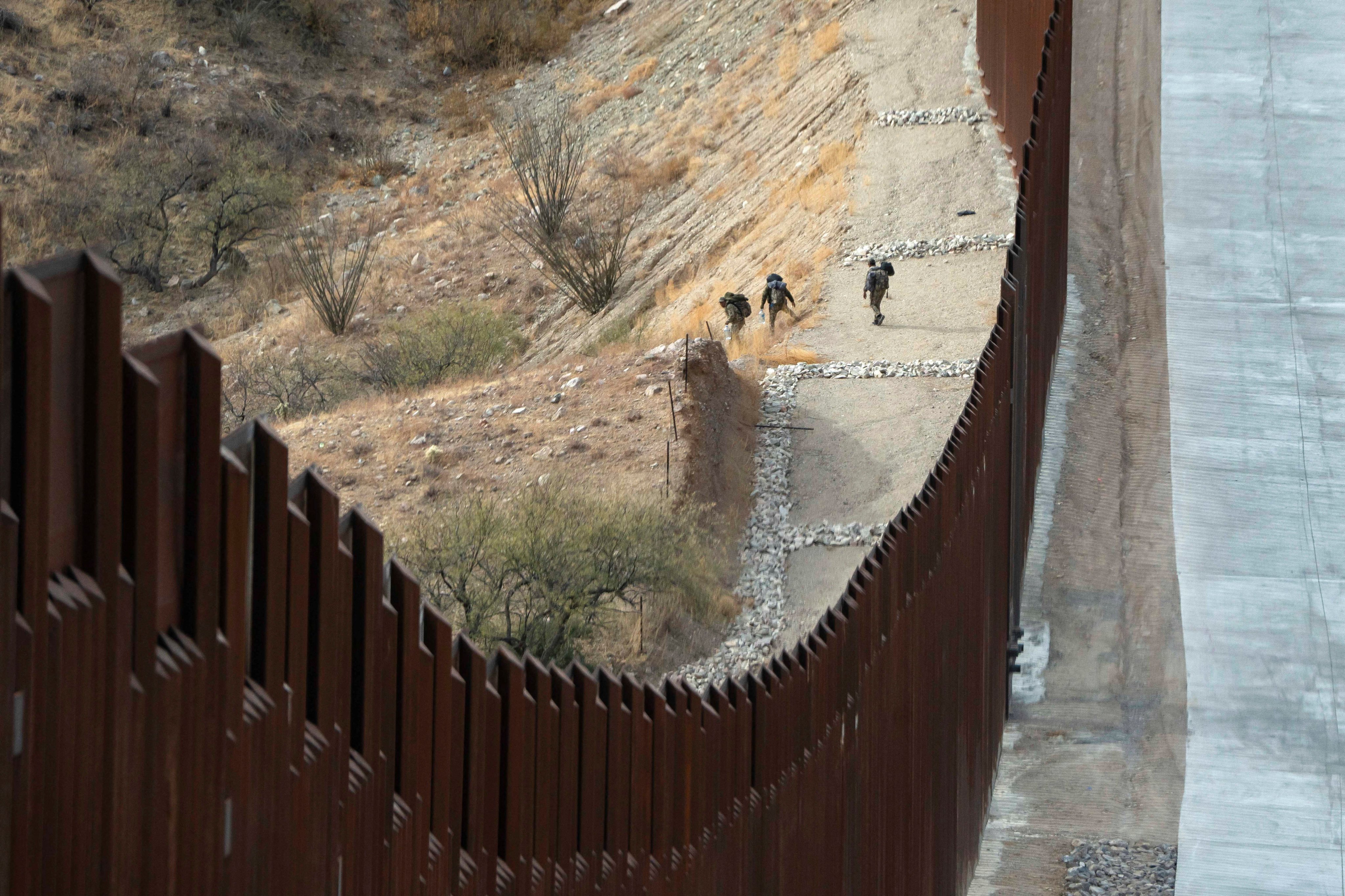 Migrants dressed in camouflage walk south of the US-Mexico border near Sasabe, Arizona. Photo: Reuters