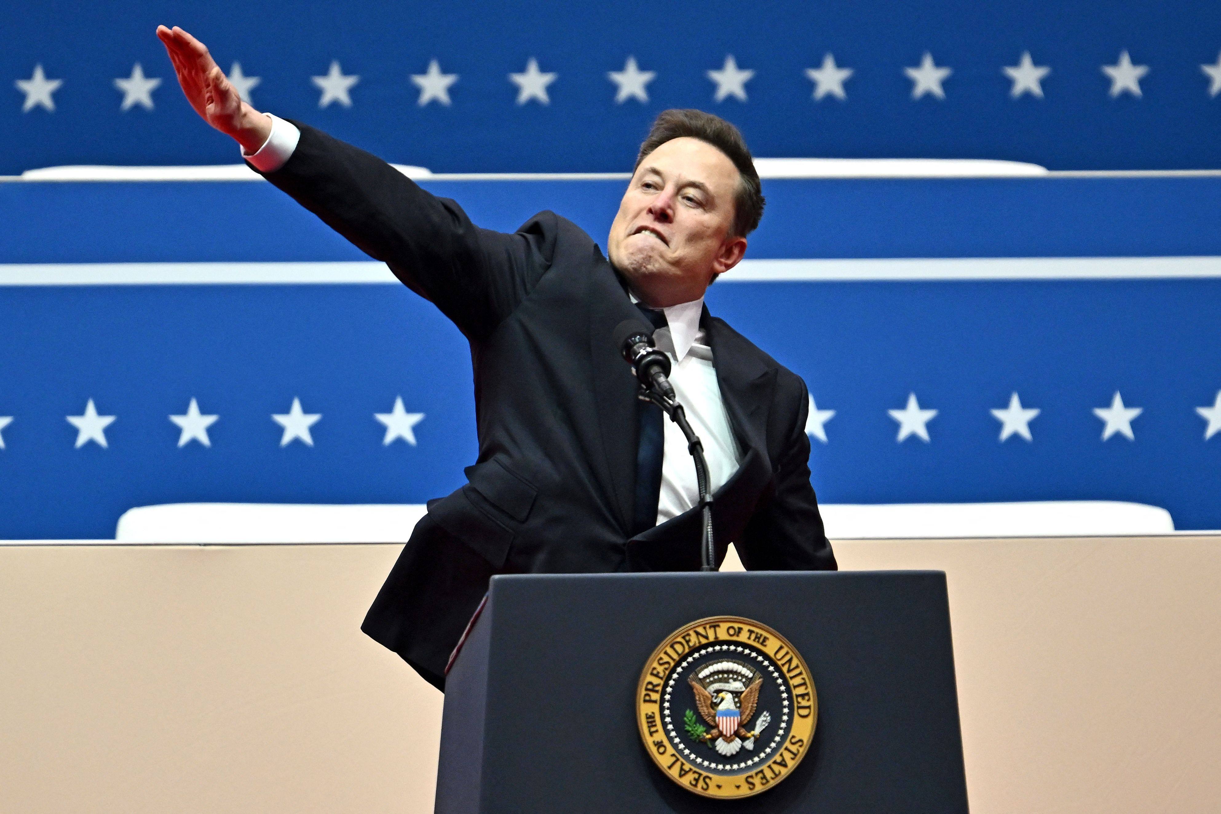 Elon Musk making a straight-arm gesture during a speech Monday. Photo: AFP
