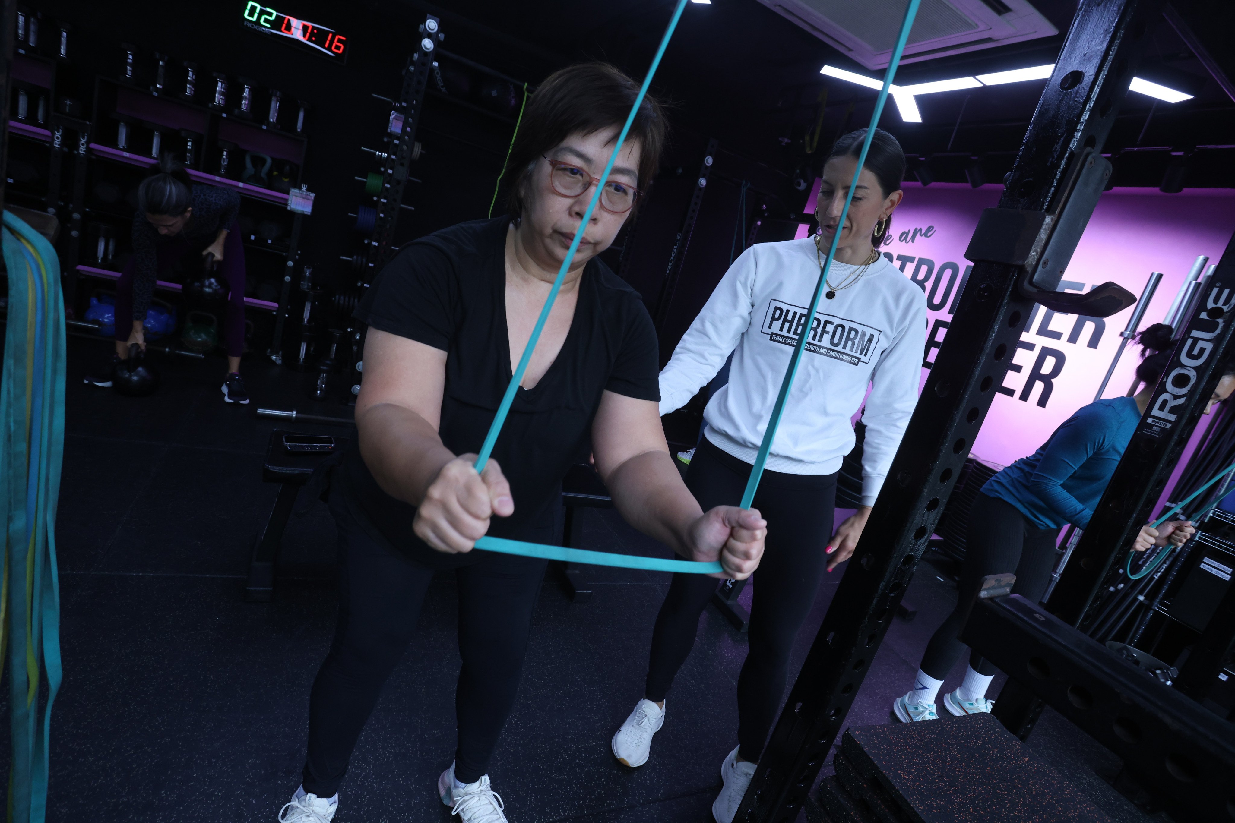 Dylis Li, 64, works out at Pherform in Hong Kong with the women-only gym’s owner, Stephanie Poelman. Photo: Jonathan Wong