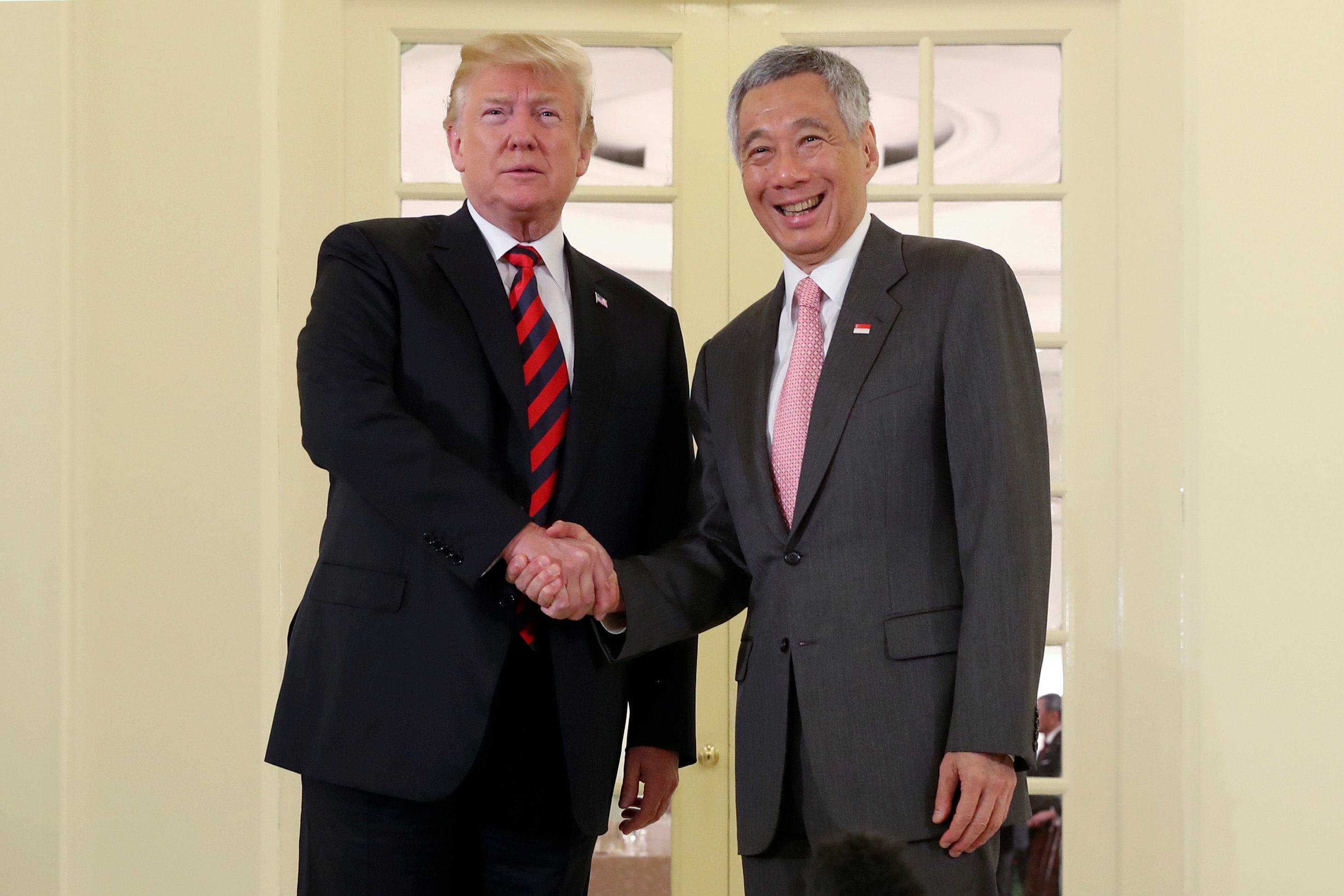 US President Donald Trump and then-Singapore Prime Minister Lee Hsien Loong shake hands at the Istana in Singapore in 2018. Photo: Reuters