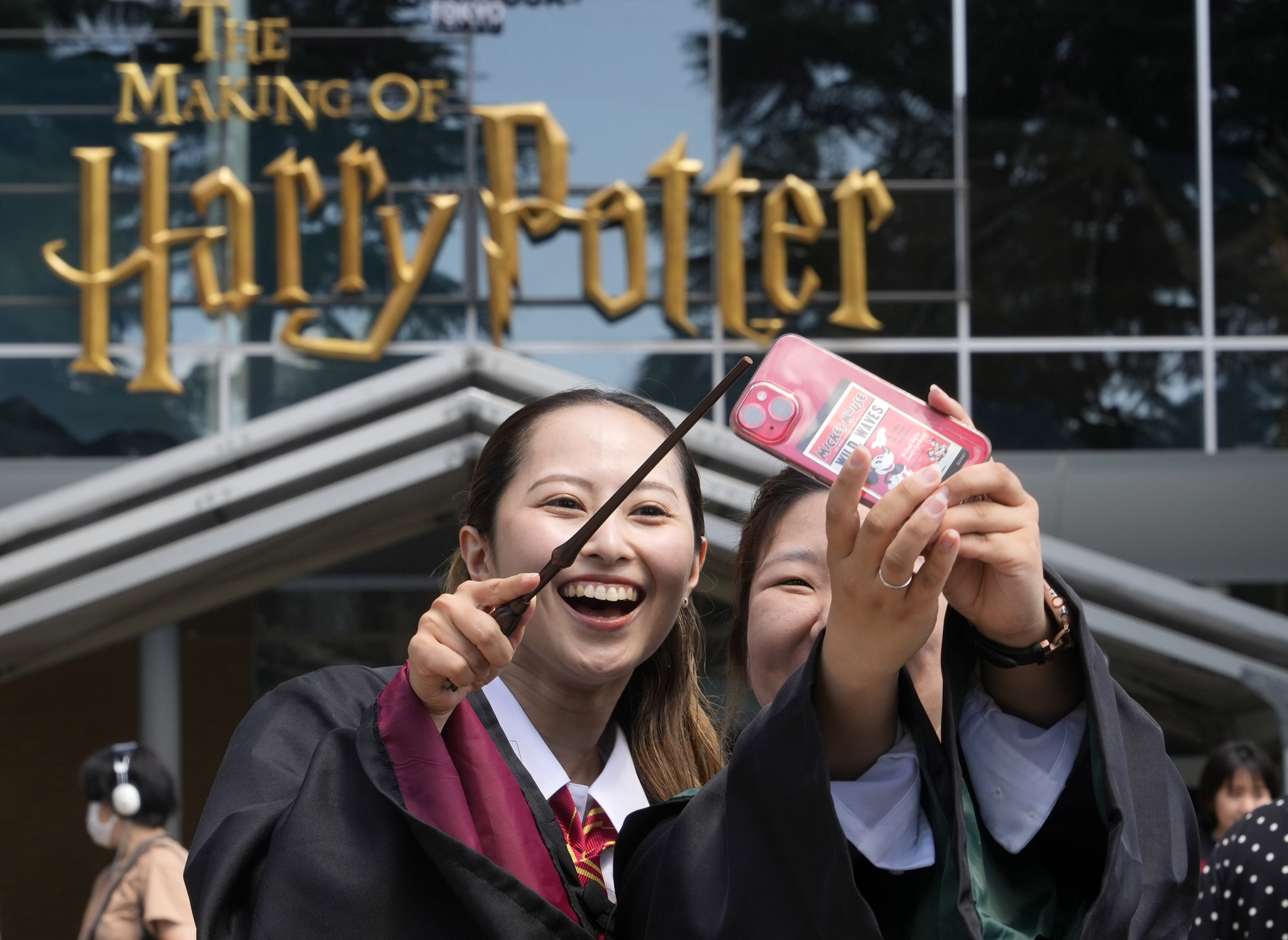 Visitors wearing costumes take selfies at the opening of a Harry Potter-themed park in Japan in 2023. Photo: EPA-EFE