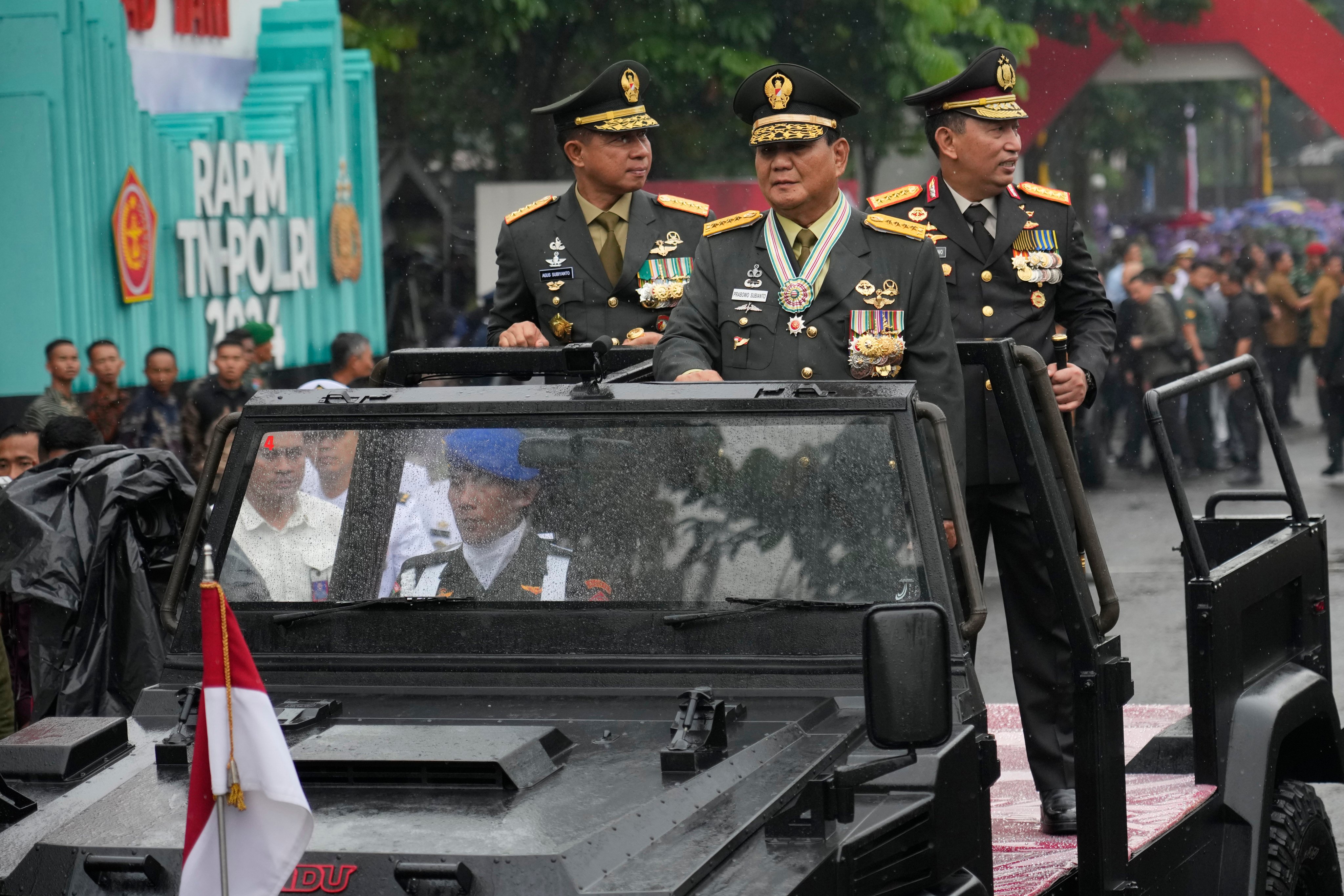 Prabowo Subianto (centre) parades through Jakarta with other defence officials last year before becoming president. Photo: AP