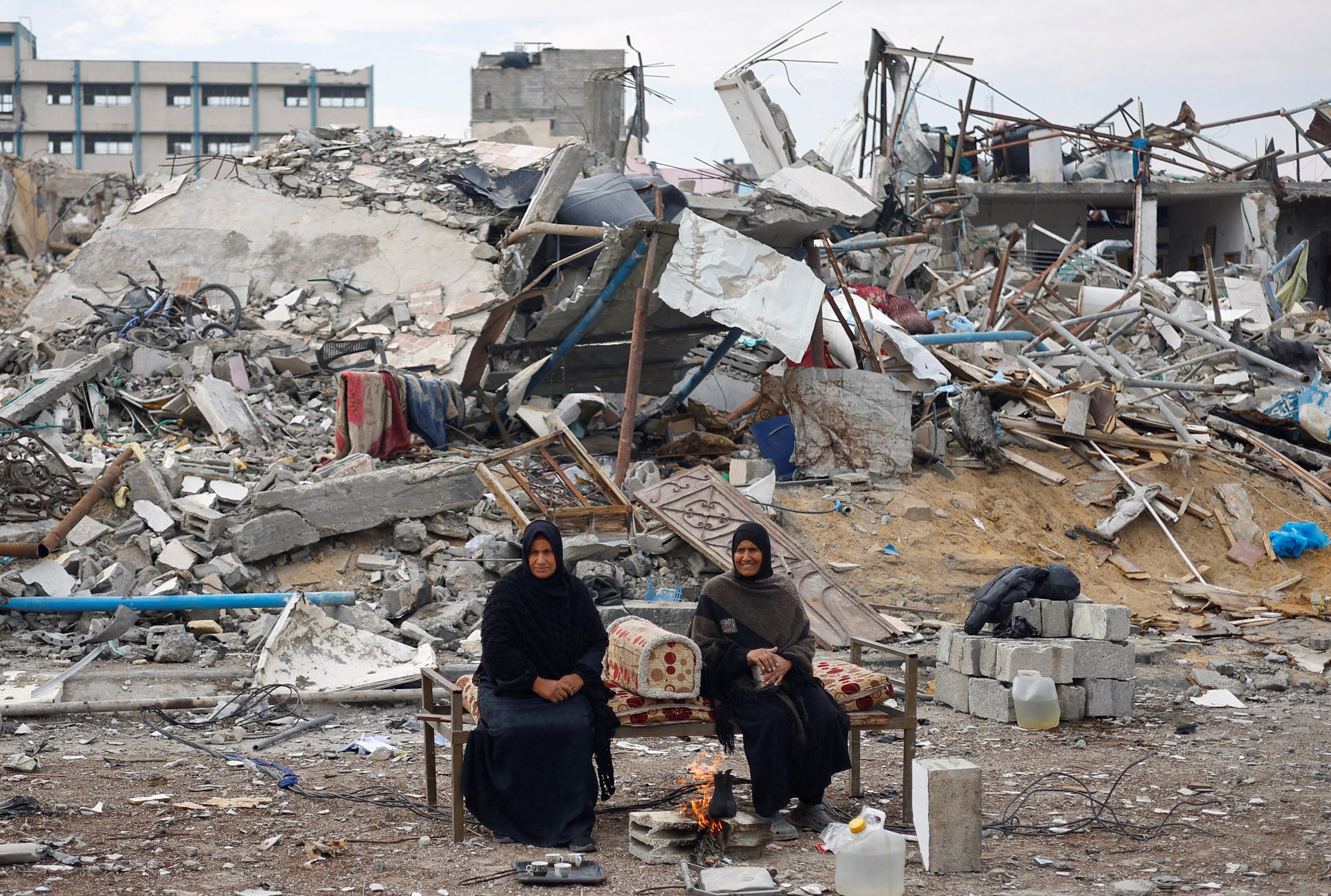 Palestinians sit near the rubble of buildings in Rafah in the southern Gaza Strip on January 22, following a ceasefire between Israel and Hamas. Photo: Reuters 