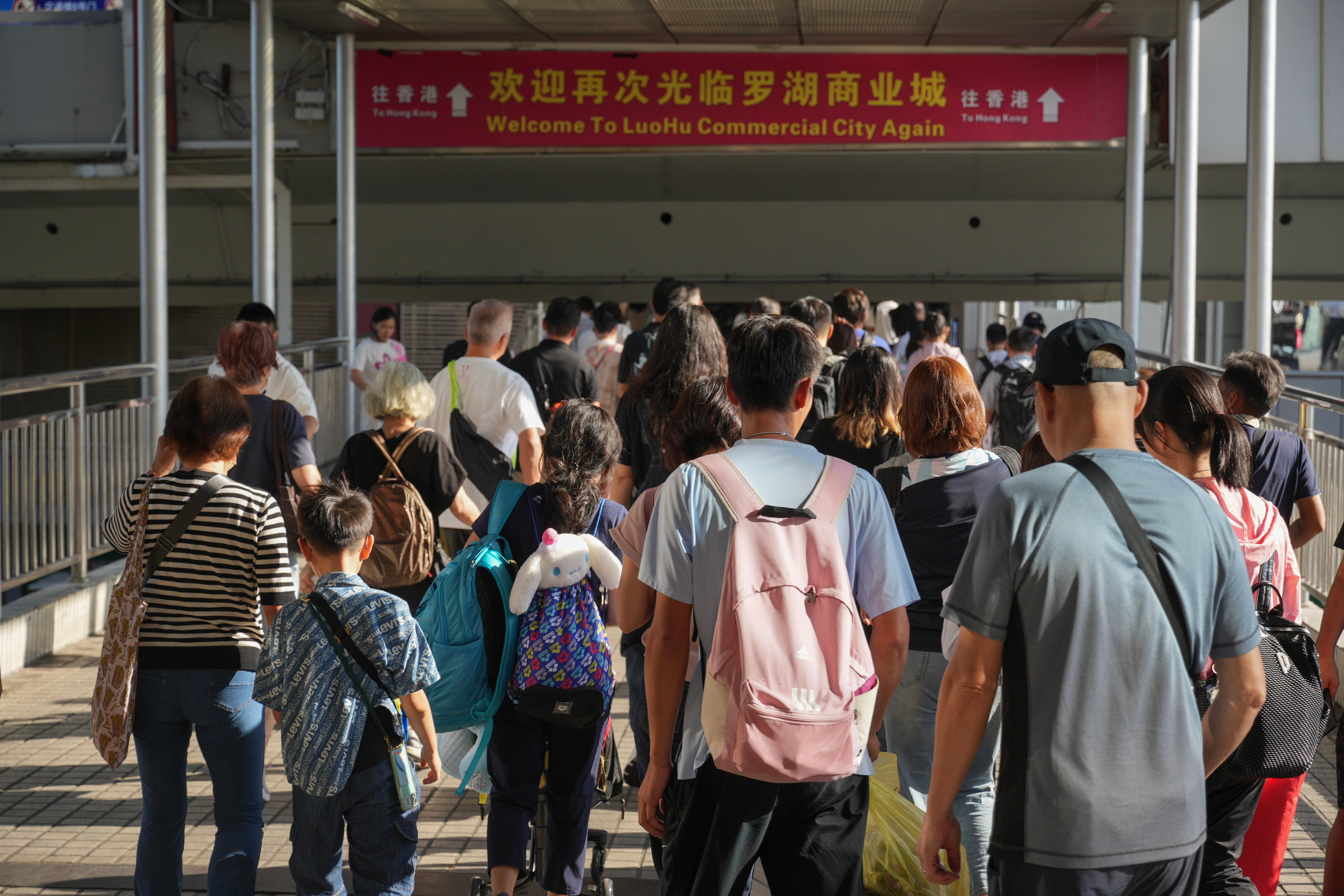 Travelers arrive at the Lo Wu border crossing in Shenzhen. Photo: May Tse