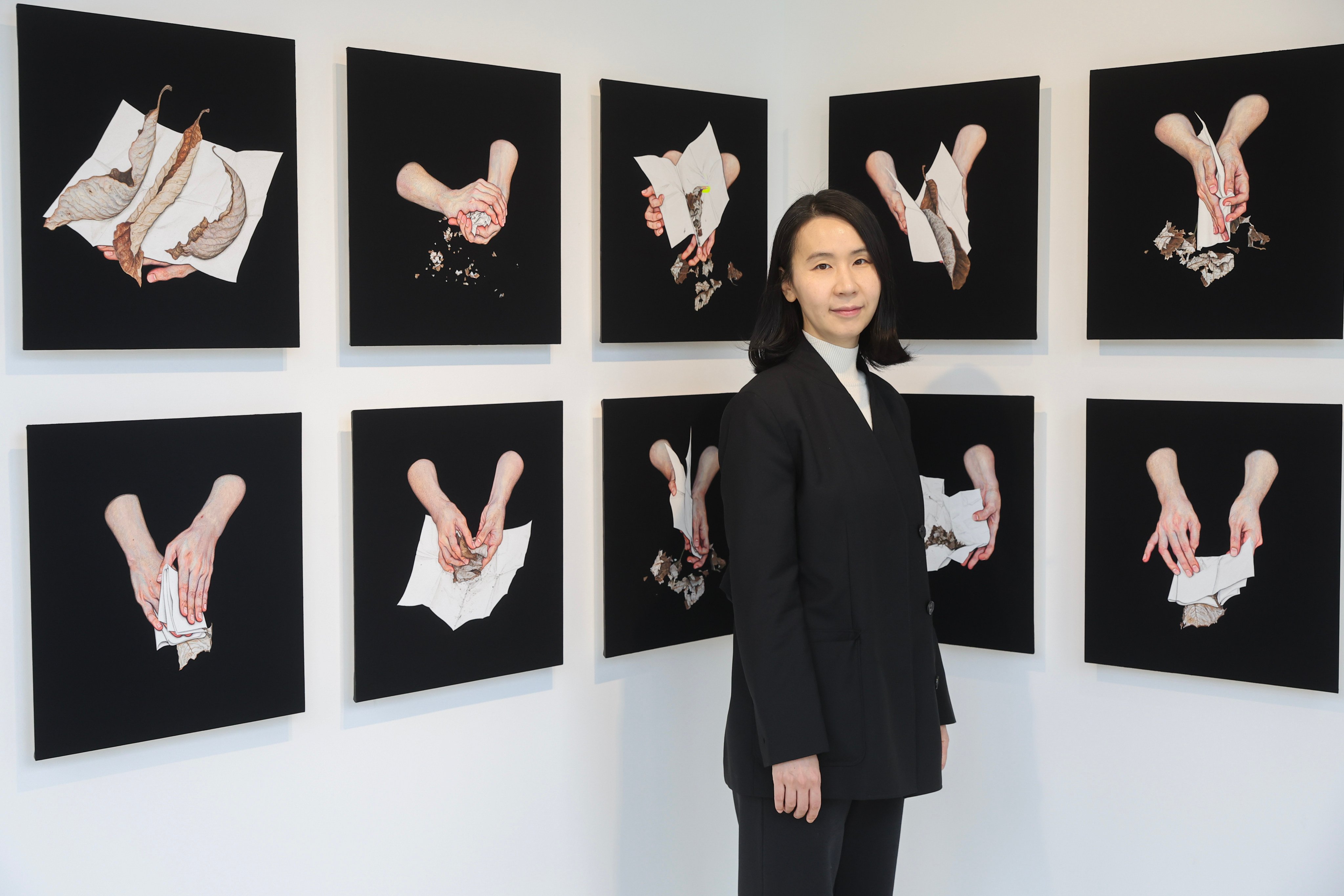 Korean artist Lee Jinju stands with works from her “Black Paintings” series at her first solo Hong Kong exhibition, at Yuz Flow: Project Space of Art in Wong Chuk Hang.
Photo: Edmond So