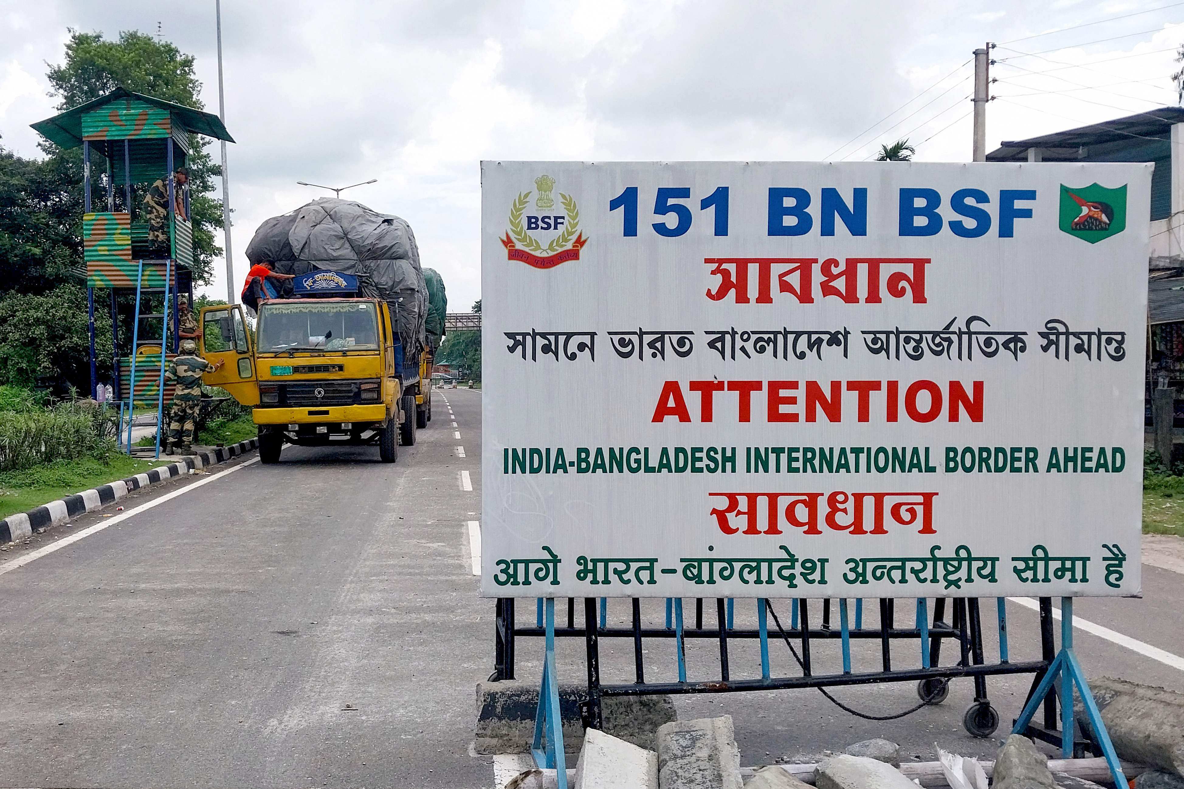 Border Security Force personnel inspect a truck carrying supplies to Bangladesh at the India-Bangladesh border in Fulbari. Photo: AFP