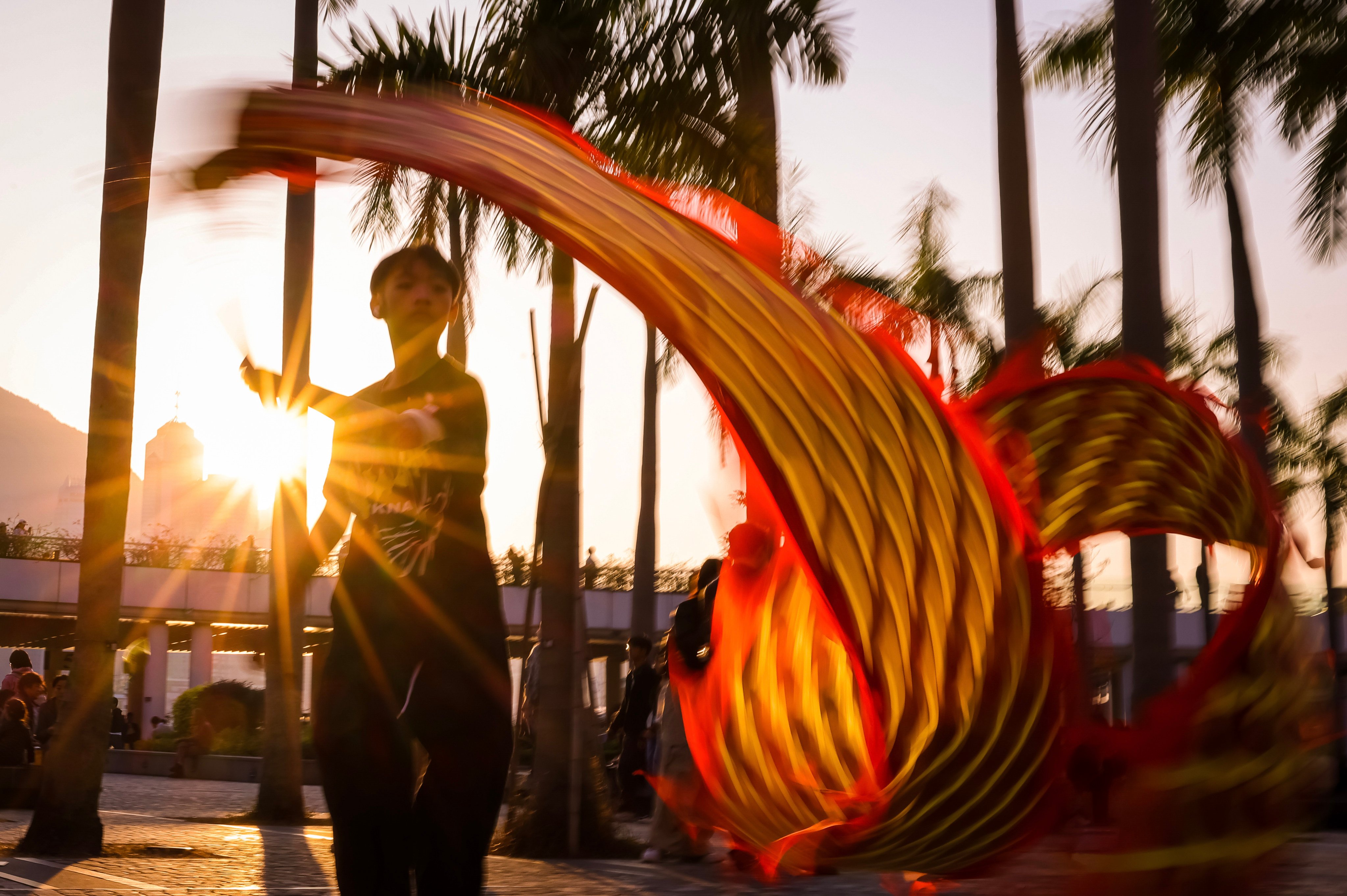 A teenager wields a fabric dragon outside the Hong Kong Cultural Centre  in Tsim Sha Tsui on January 4. Photo: Nora Tam