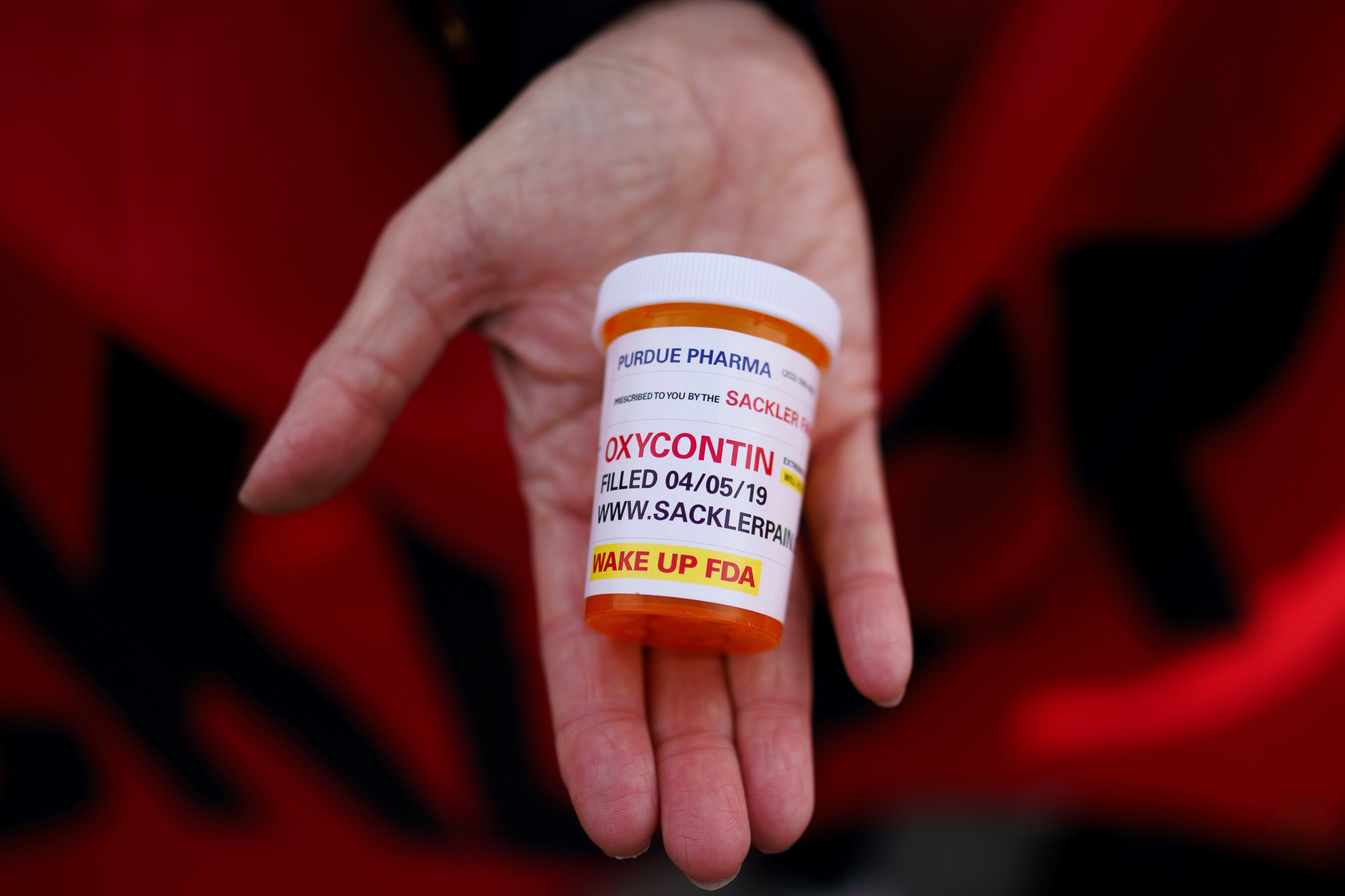 A campaigner holds an OxyContin pill container outside the US Supreme Court in December 2023. Photo: EPA-EFE