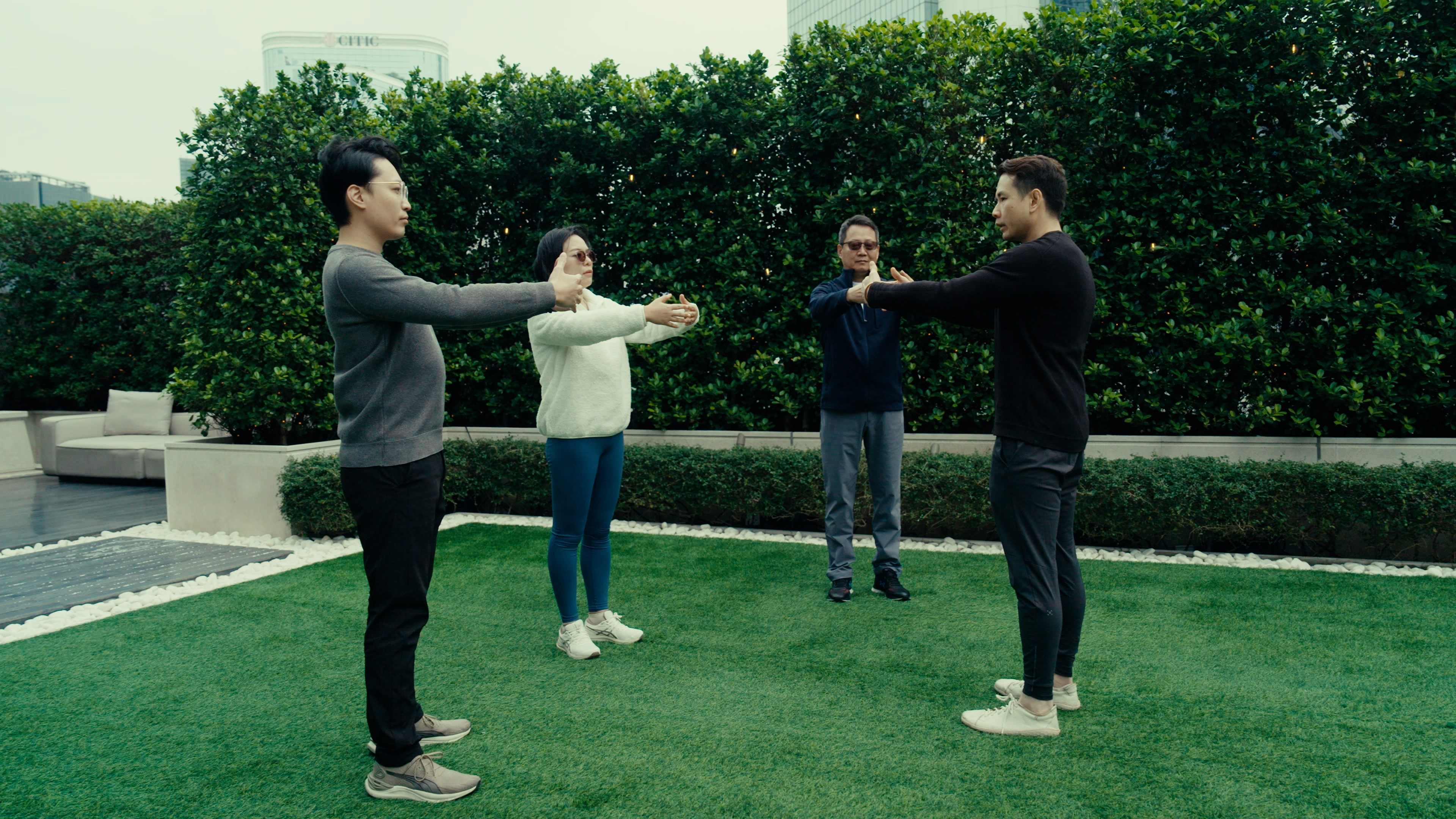 Three life and health tech company founders from Hong Kong Science Park practise breathwork with specialist Brian Lai (right), to help them stay in top form for their innovative work.