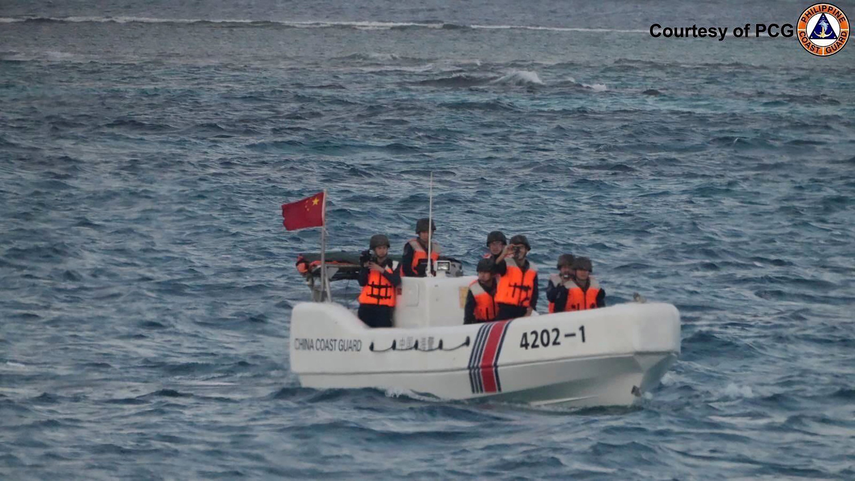 In this image released by the Philippine Coast Guard, a Chinese boat sails around Sandy Cay. Photo: AP