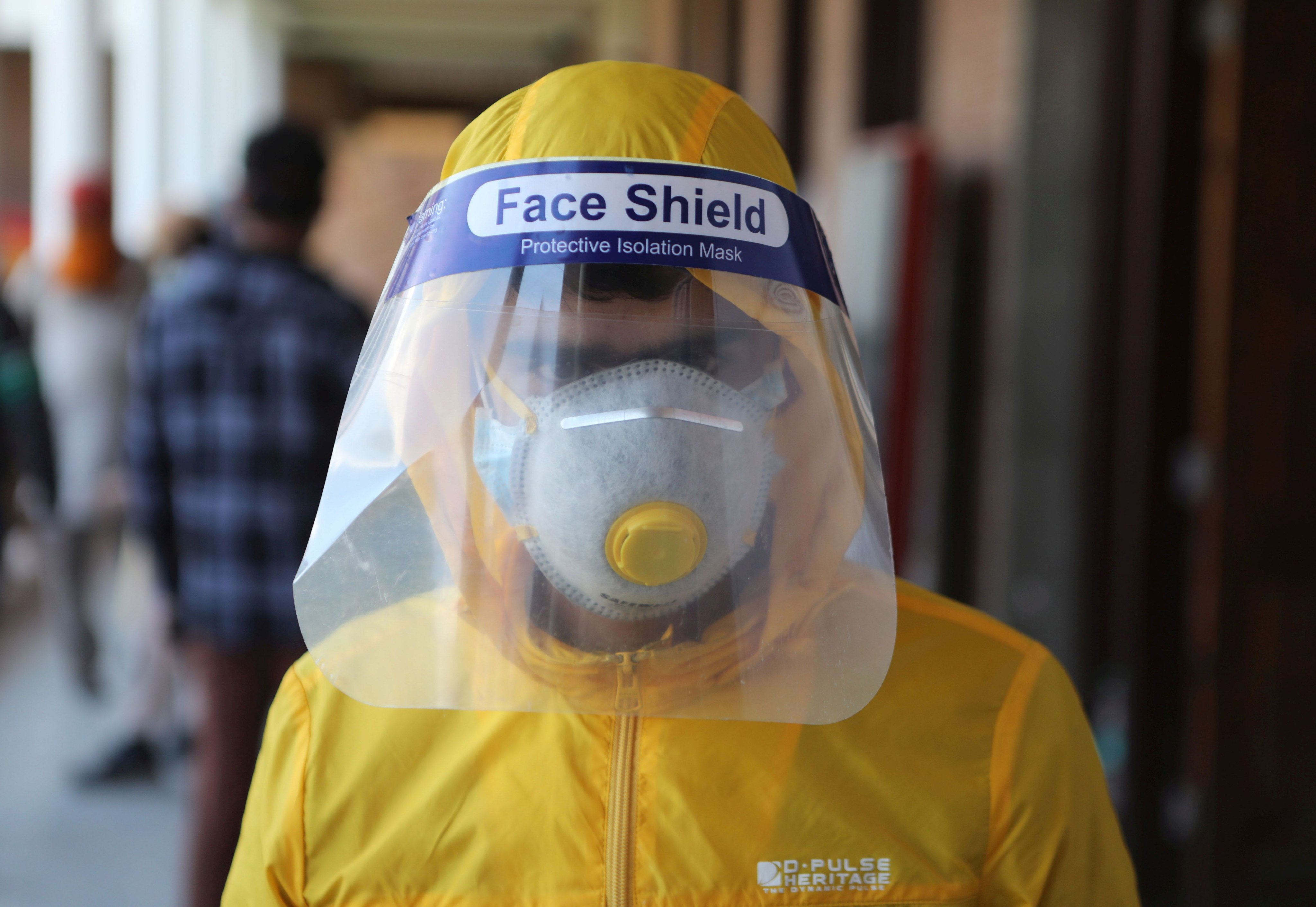 A Kashmiri boy wearing a mask and face shield in Srinagar, the summer capital of Indian Kashmir, in May of 2020. Photo: EPA-EFE