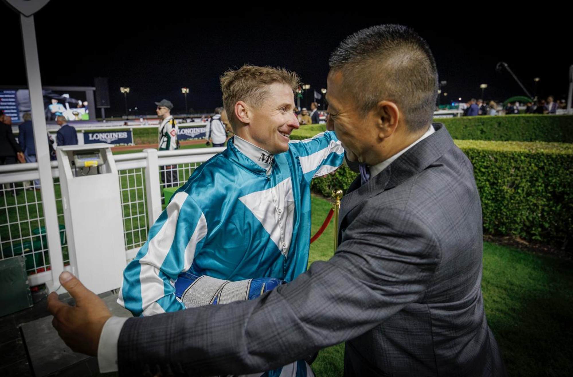 Jockey James McDonald and trainer Danny Shum embrace after Romantic Warrior’s win.