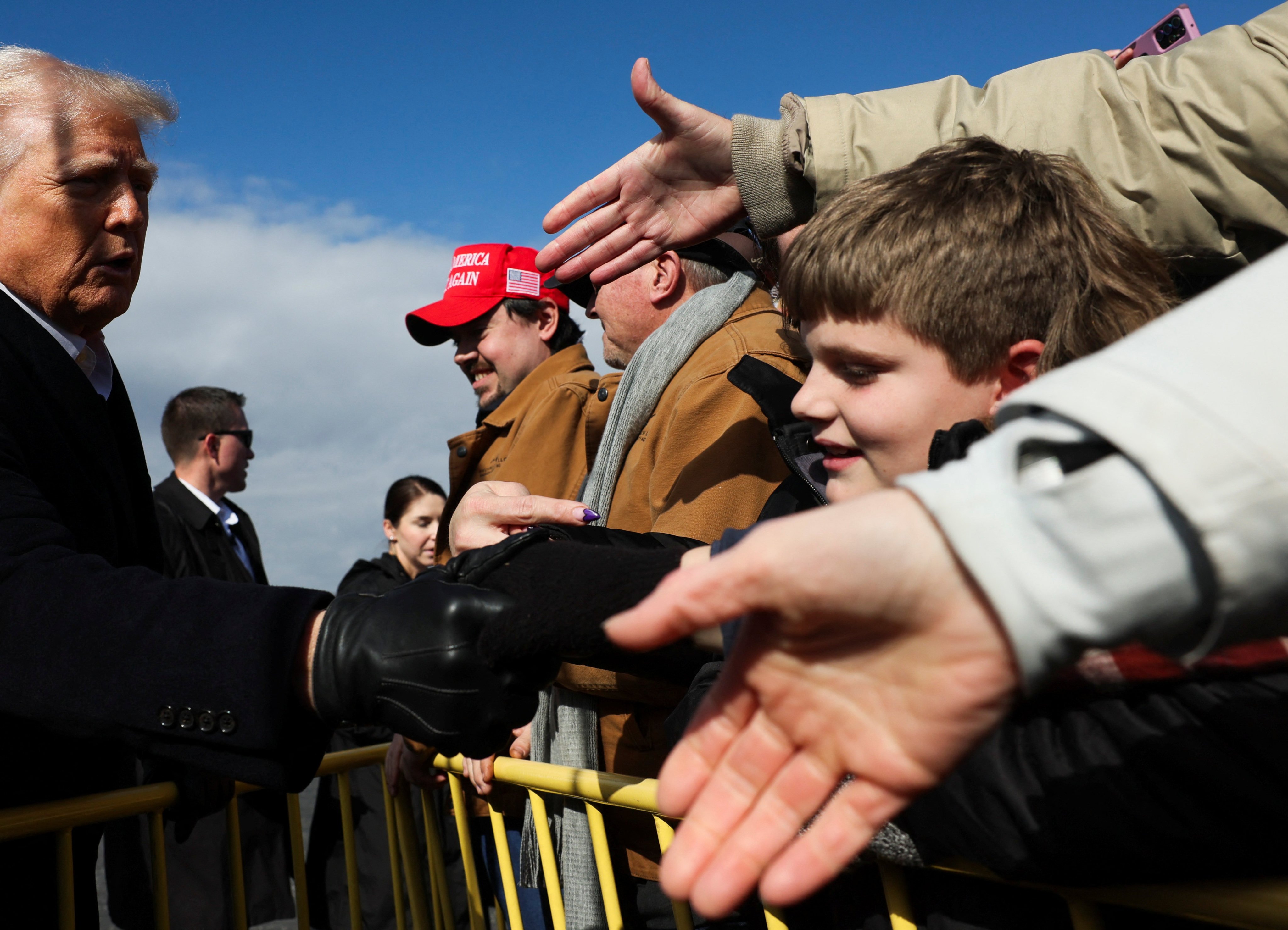 US President Donald Trump greets supporters, as he arrives to assess recovery efforts and tour areas devastated by Hurricane Helene in Asheville, North Carolina, on Friday. Photo: Reuters