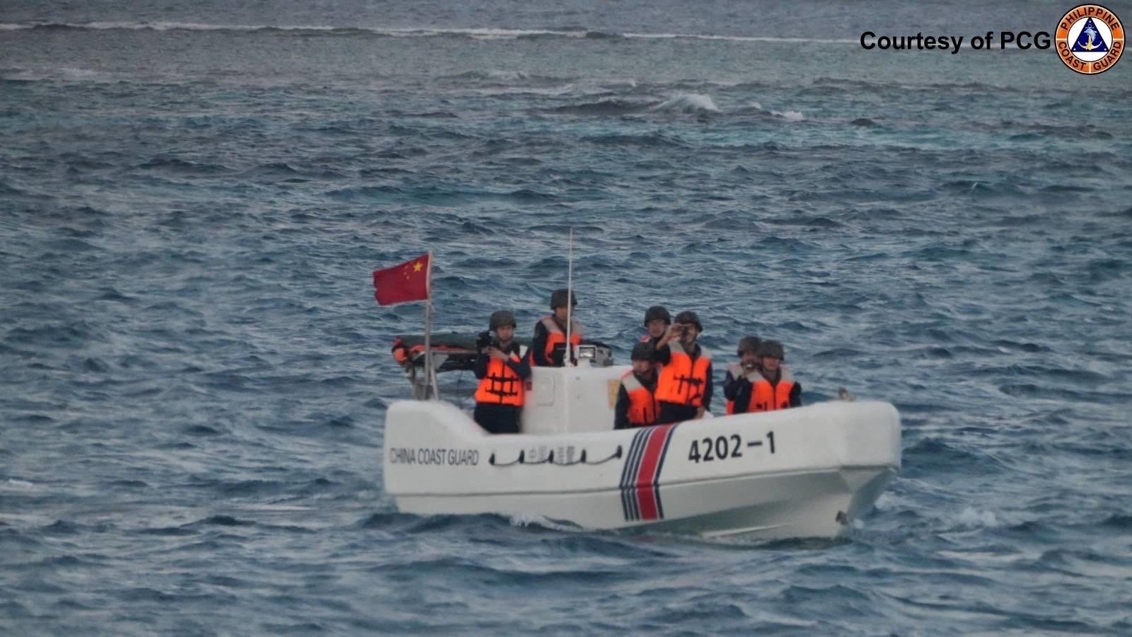 Chinese coastguard officers check an incident with the Philippine fisheries bureau during a survey in the South China Sea on January 24. Photo: PCG/AFP
