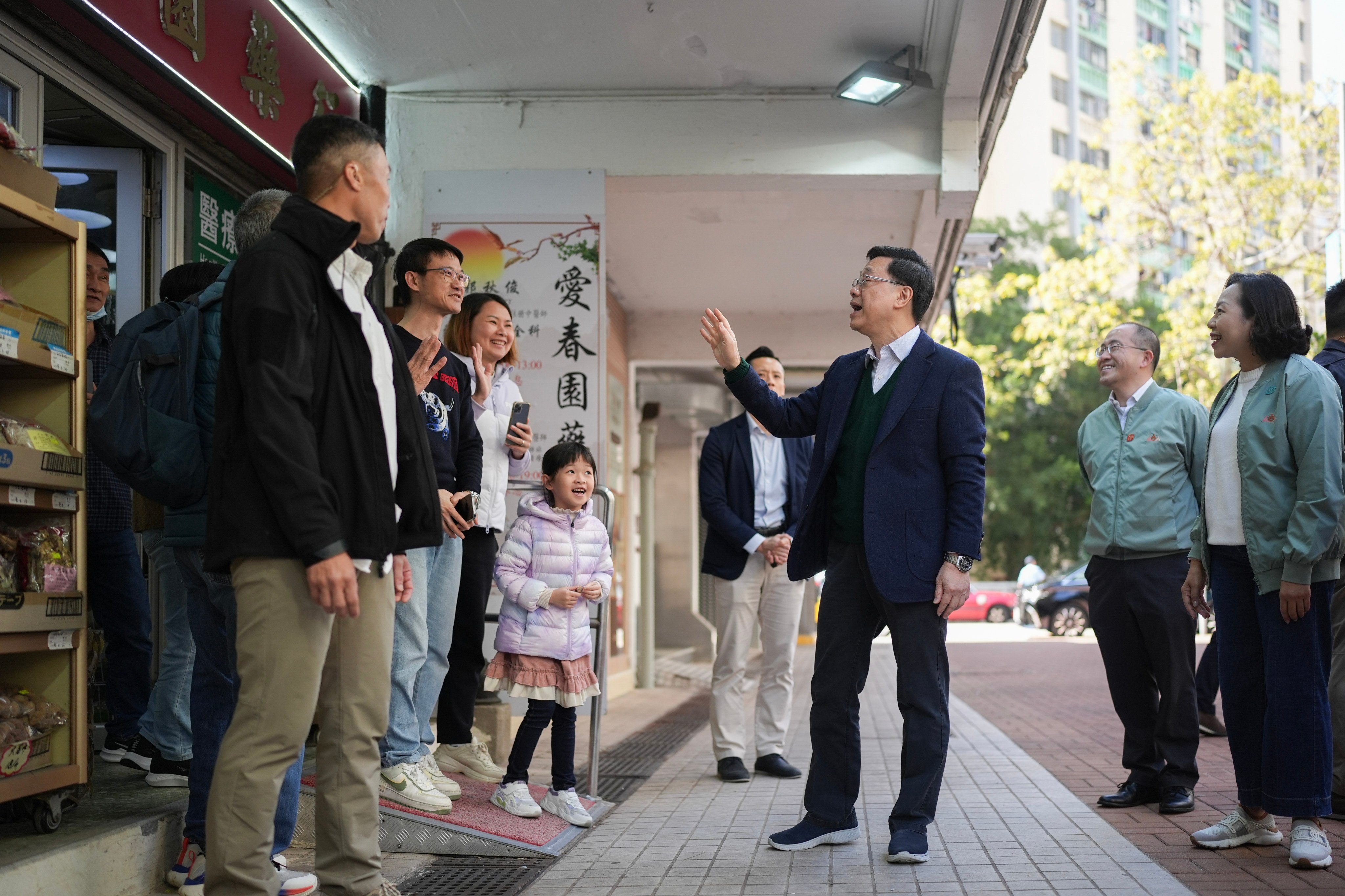 Chief Executive John Lee greets residents at Oi Man Estate in Ho Man Tin. Photo: Eugene Lee