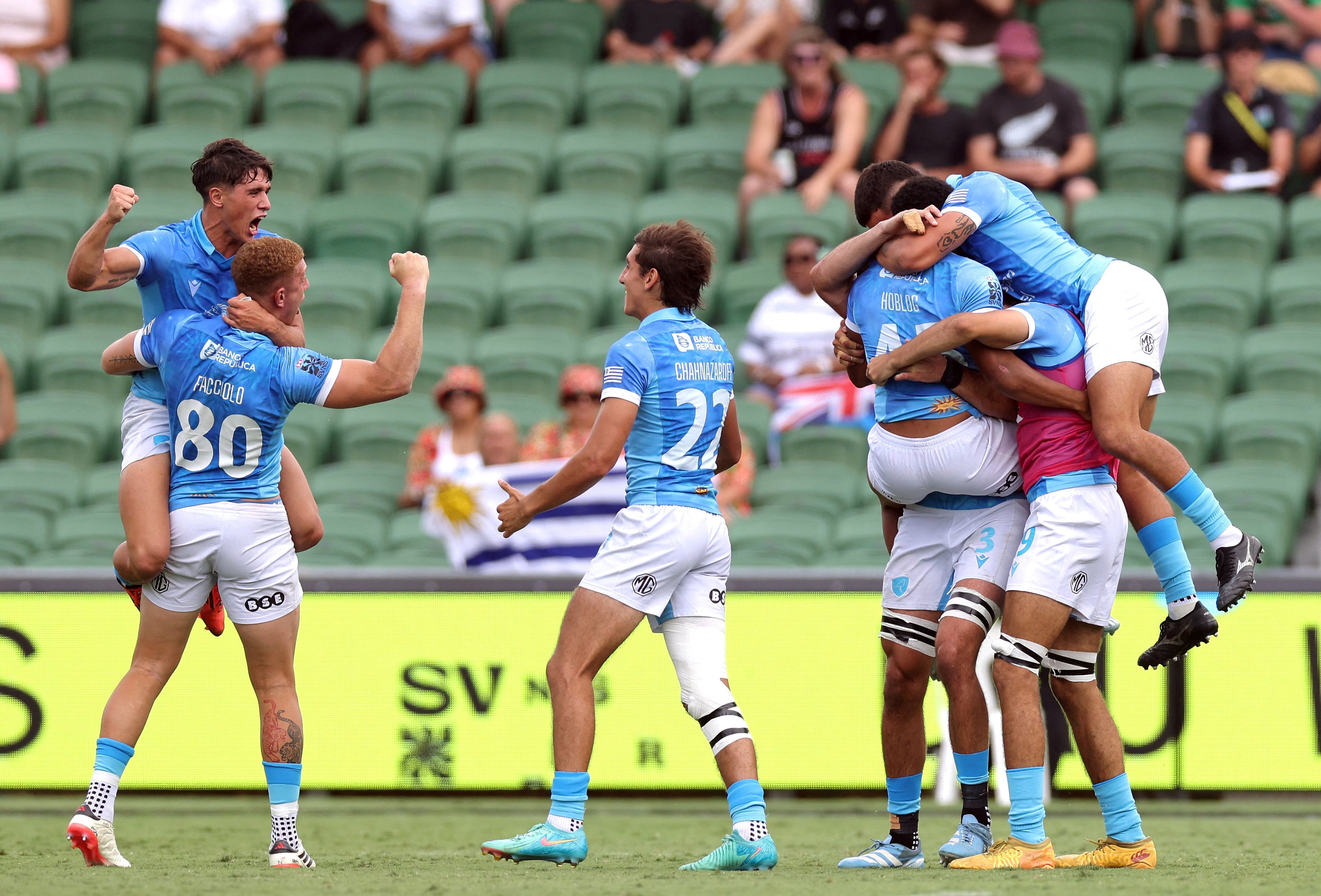 Uruguay players celebrate after beating the All Blacks on the opening day of the World Sevens Series stop in Perth. Photo: Reuters