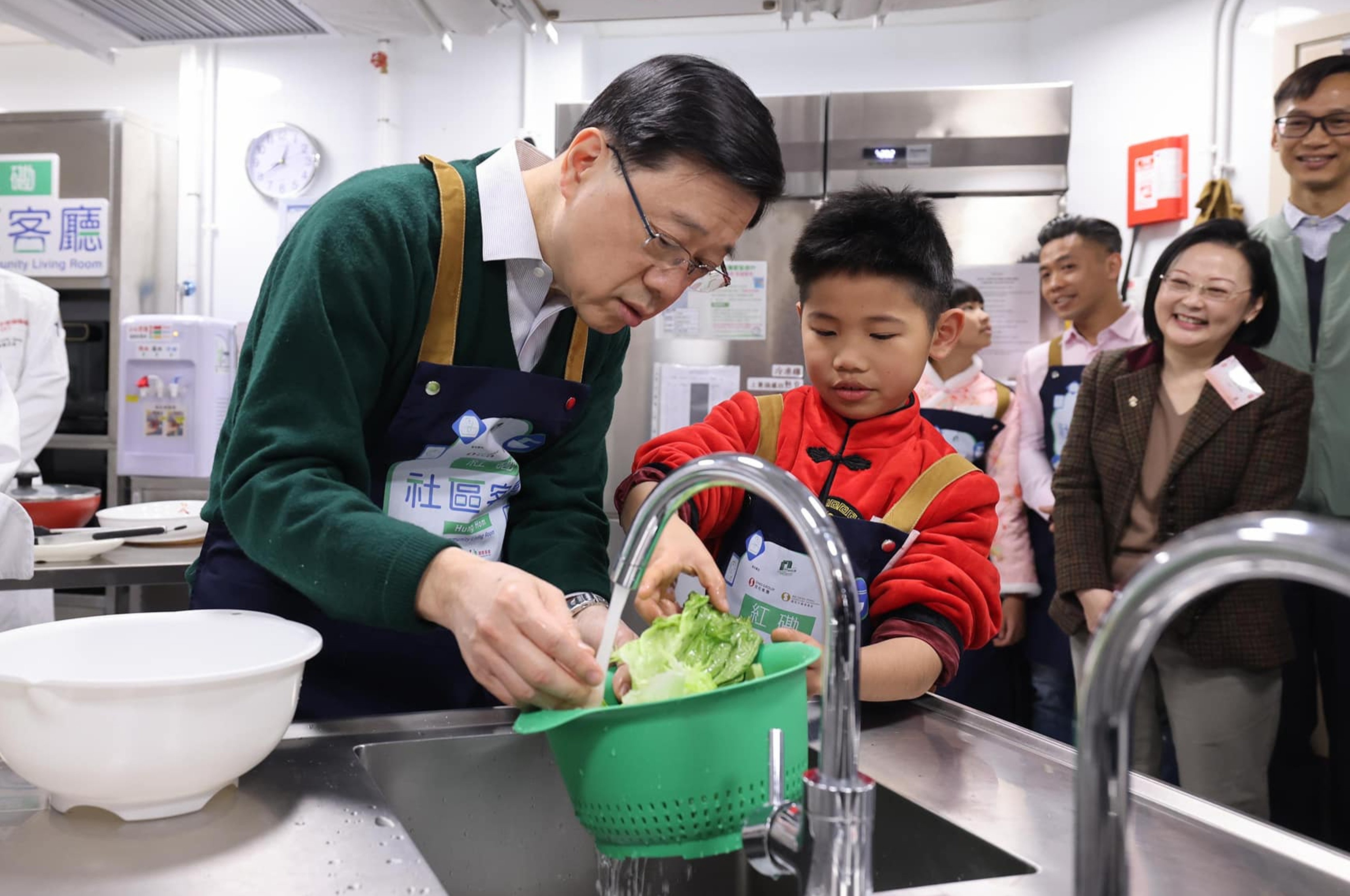 Chief Executive John Lee helps prepare food at a community living room. Photo: Handout