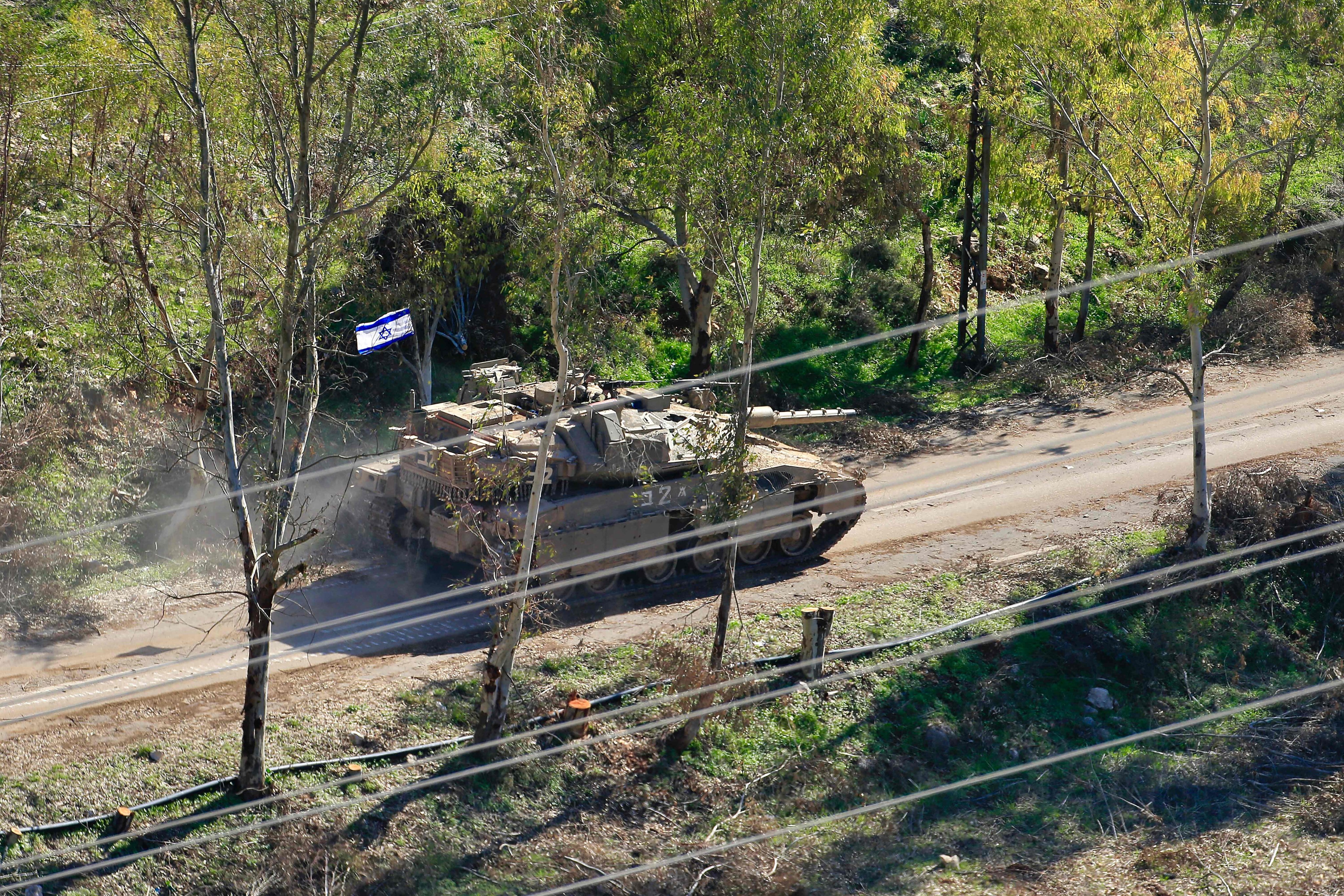 This picture taken from Lebanon’s southern village of Shaqra on Saturday shows an Israeli army tank moving along a road on the outskirts of the village of Mais al-Jabal along the border with Israel in south Lebanon. Photo: AFP