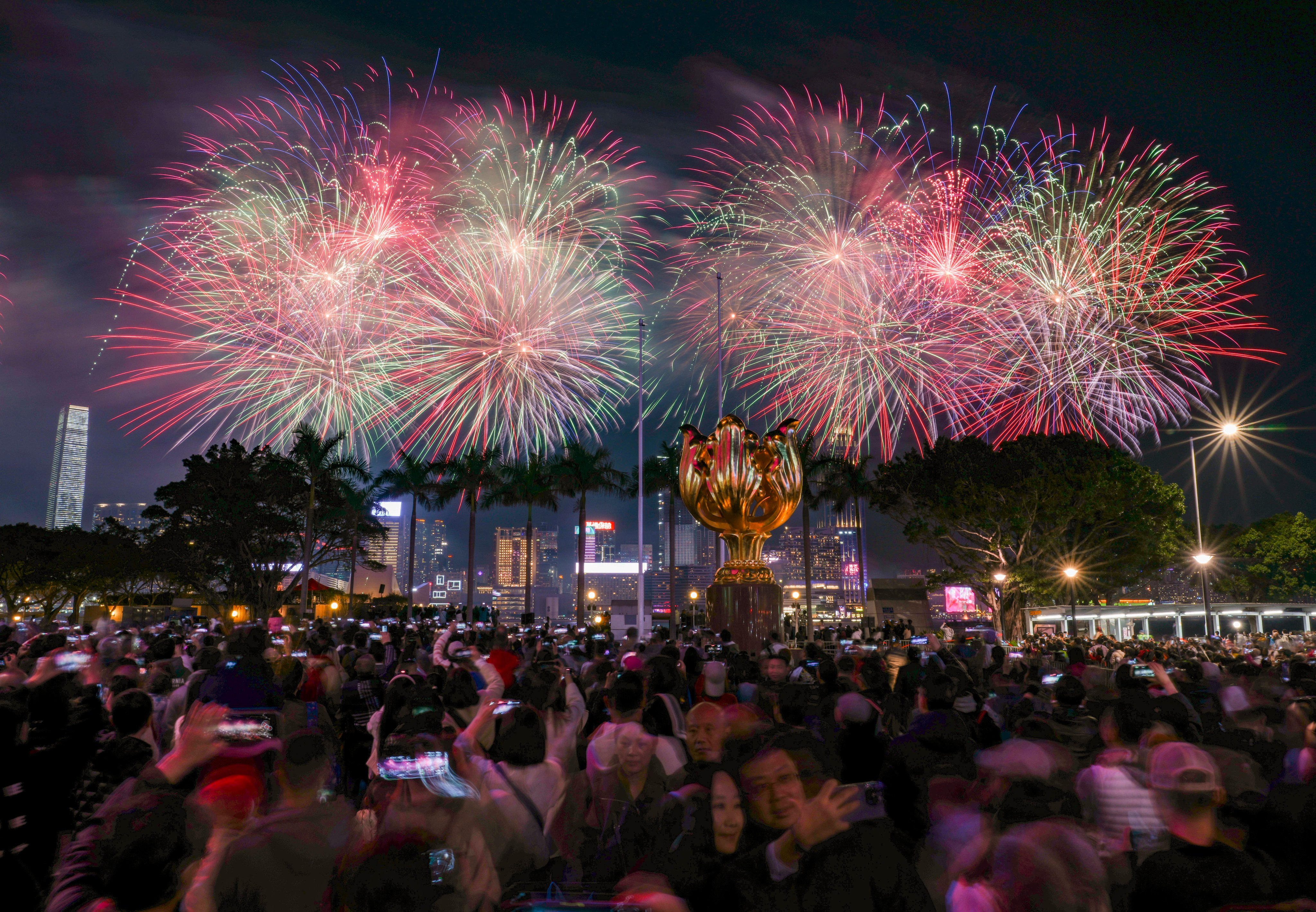 Hongkongers admire the Lunar New Year fireworks at the Golden Bauhinia Square in Wan Chai on February 11, 2024. Photo: Eugene Lee