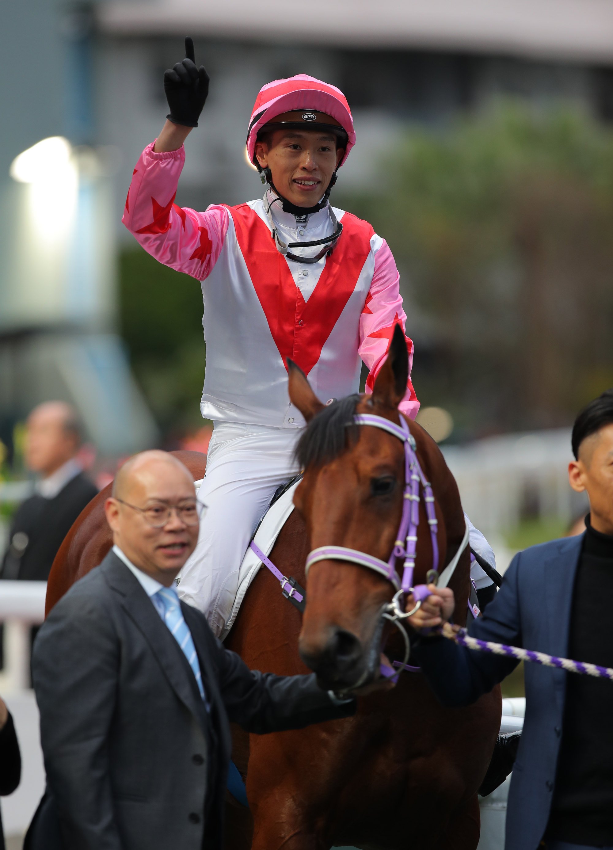 Jockey Vincent Ho and trainer Chris So enjoy The Boom Box’s victory.