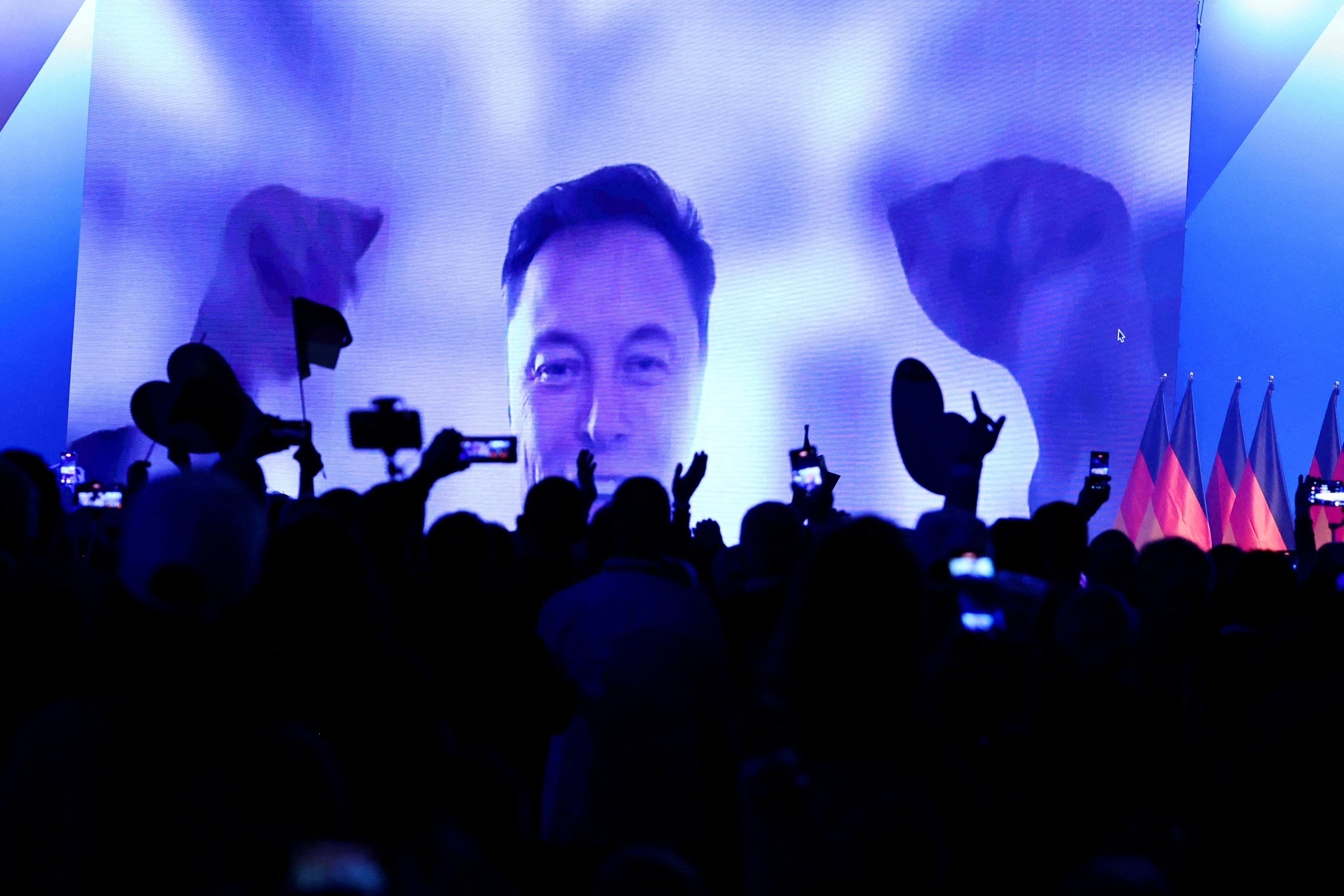 SpaceX CEO Elon Musk speaks on-screen during an AfD campaign event in Halle, Germany, on Saturday. Photo: Reuters