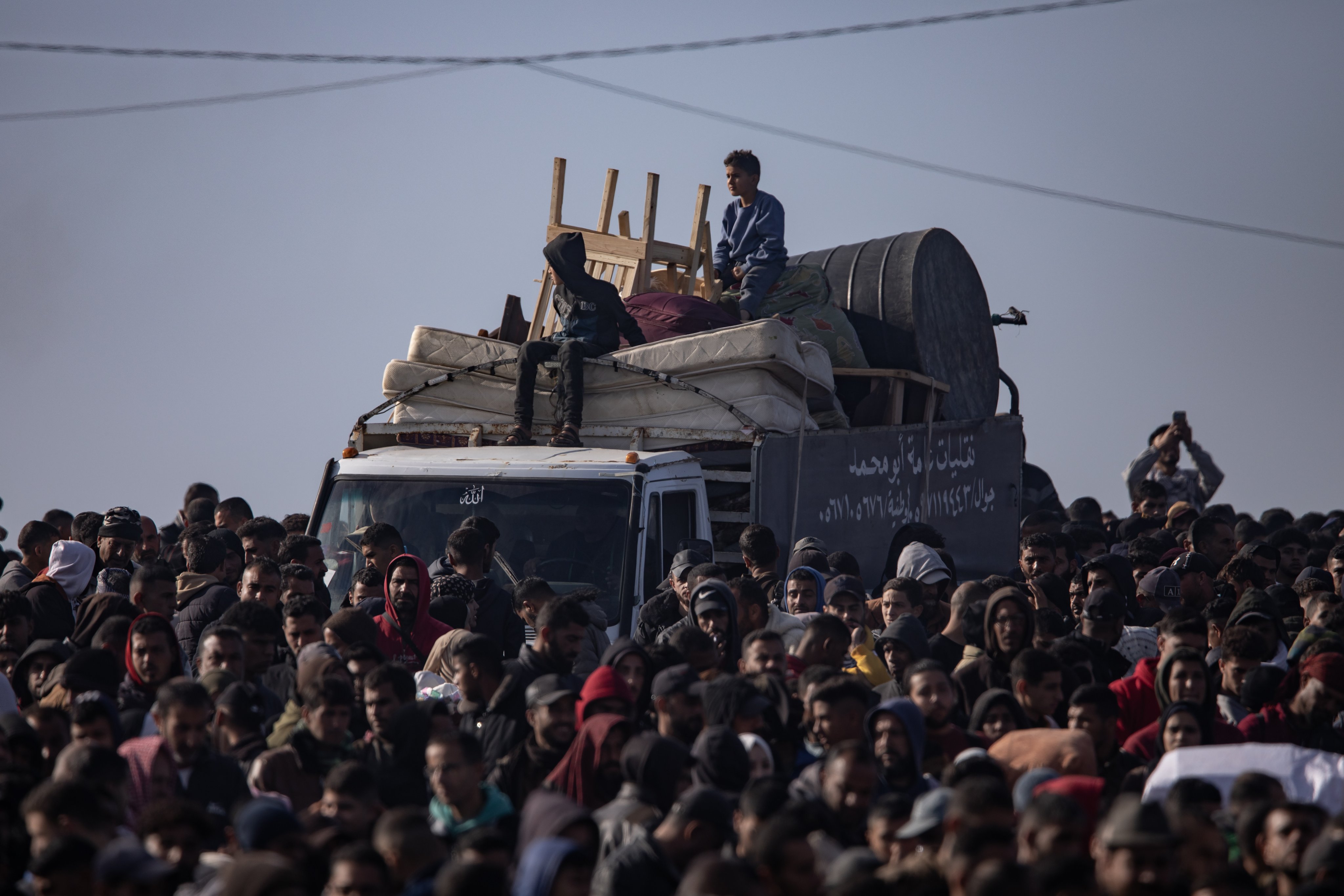 Palestinian families wait to return to the northern Gaza Strip from the southern Gaza Strip, in central Gaza on Saturday. Photo: EPA-EFE