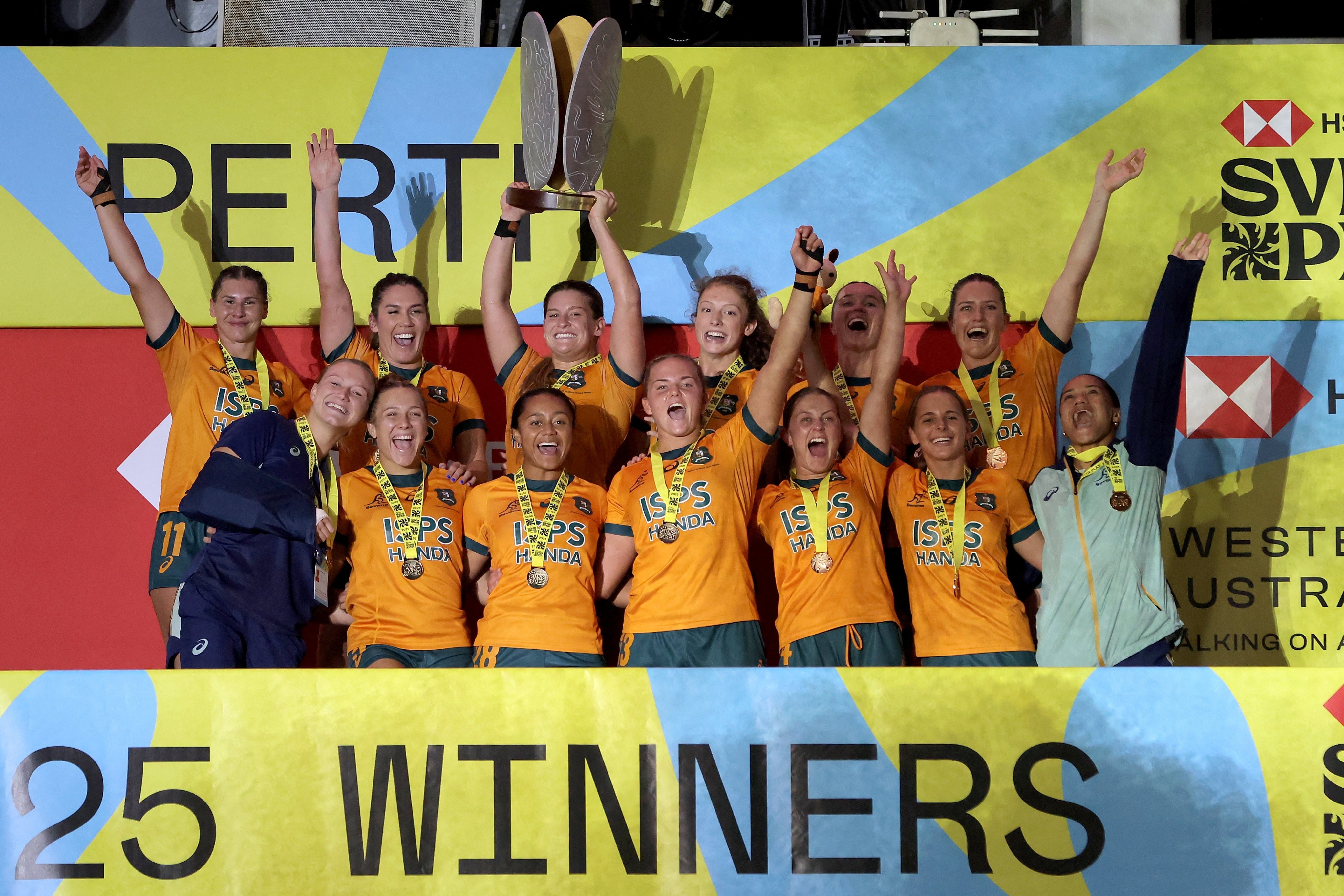 Australia’s women celebrate their triumph at the Perth Sevens after a nail-biting 28-26 victory over neighbours New Zealand in the final. Photo: Reuters