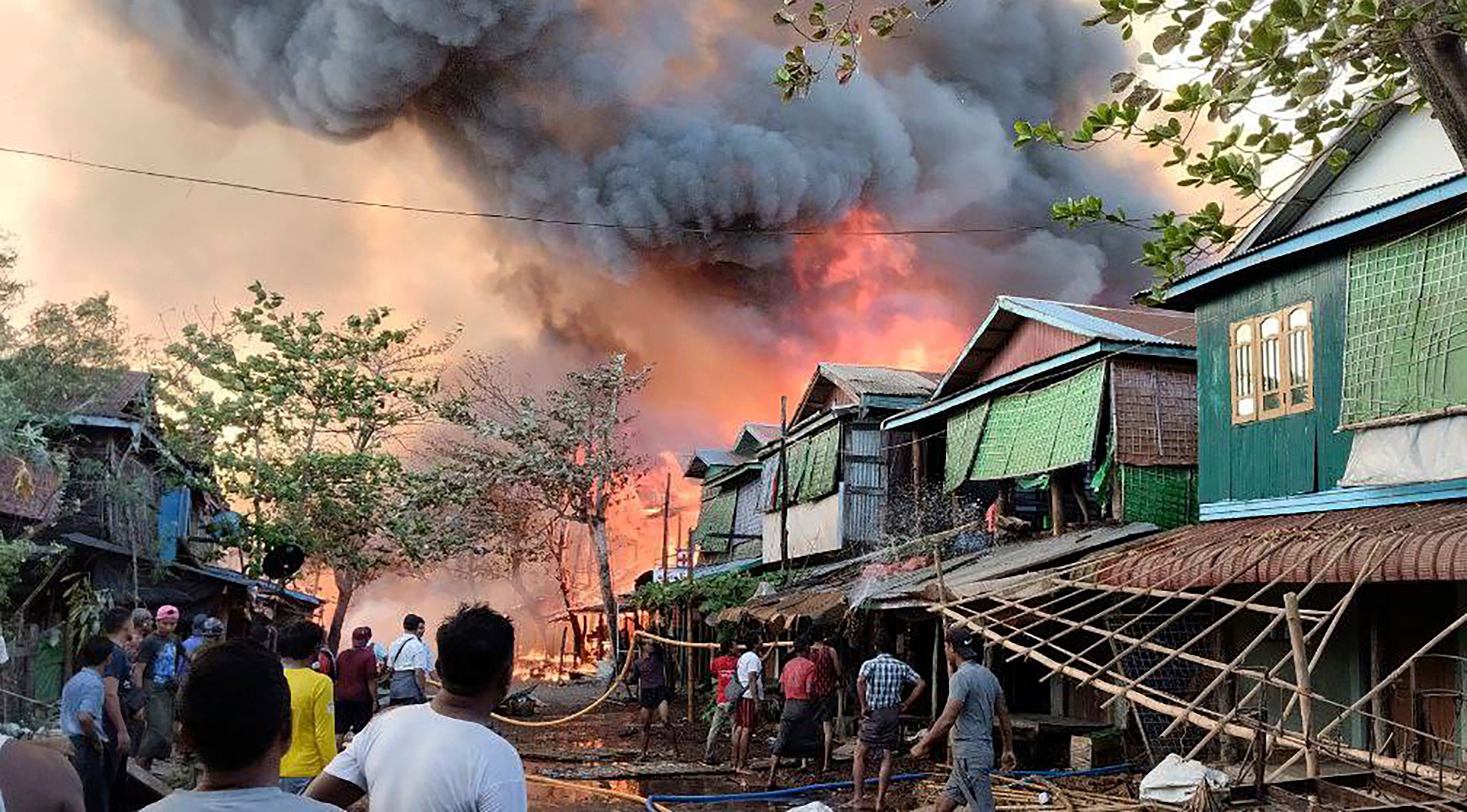 Houses burn on January 8 in a township in Myanmar’s Rakhine state after a suspected junta airstrike. Photo: Arakan Army via AP