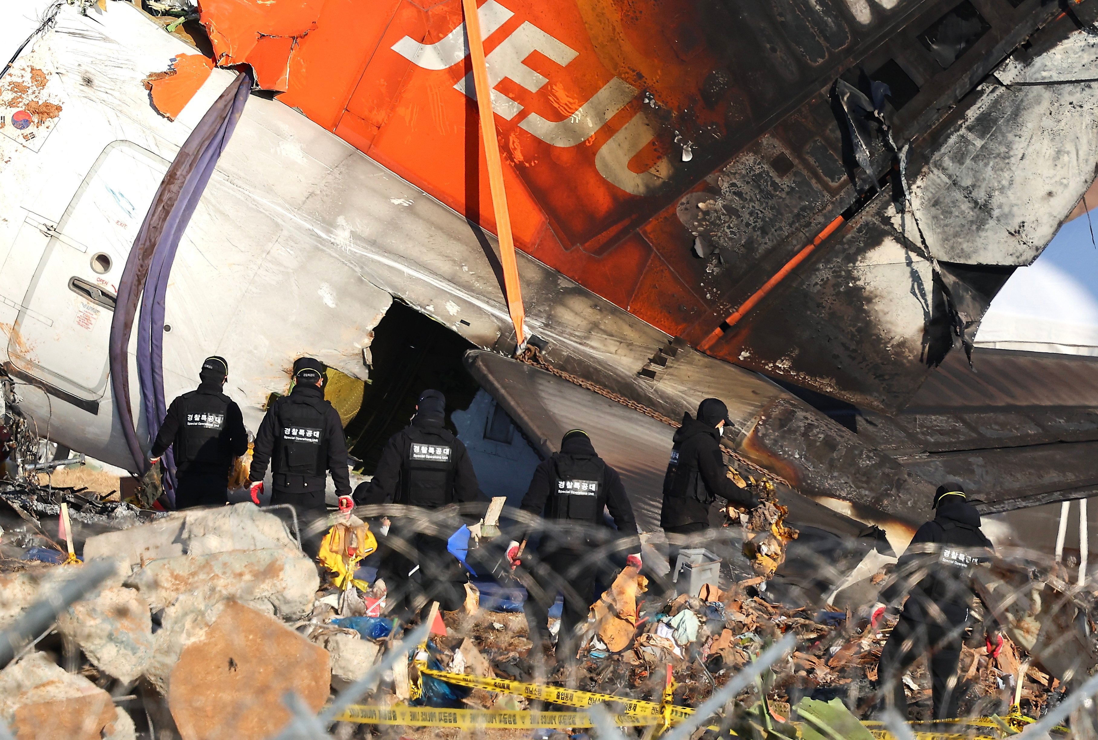 A forensics team inspects the wreckage of the Jeju Air plane that crashed at Muan International Airport. Photo: Yonhap/EPA-EFE