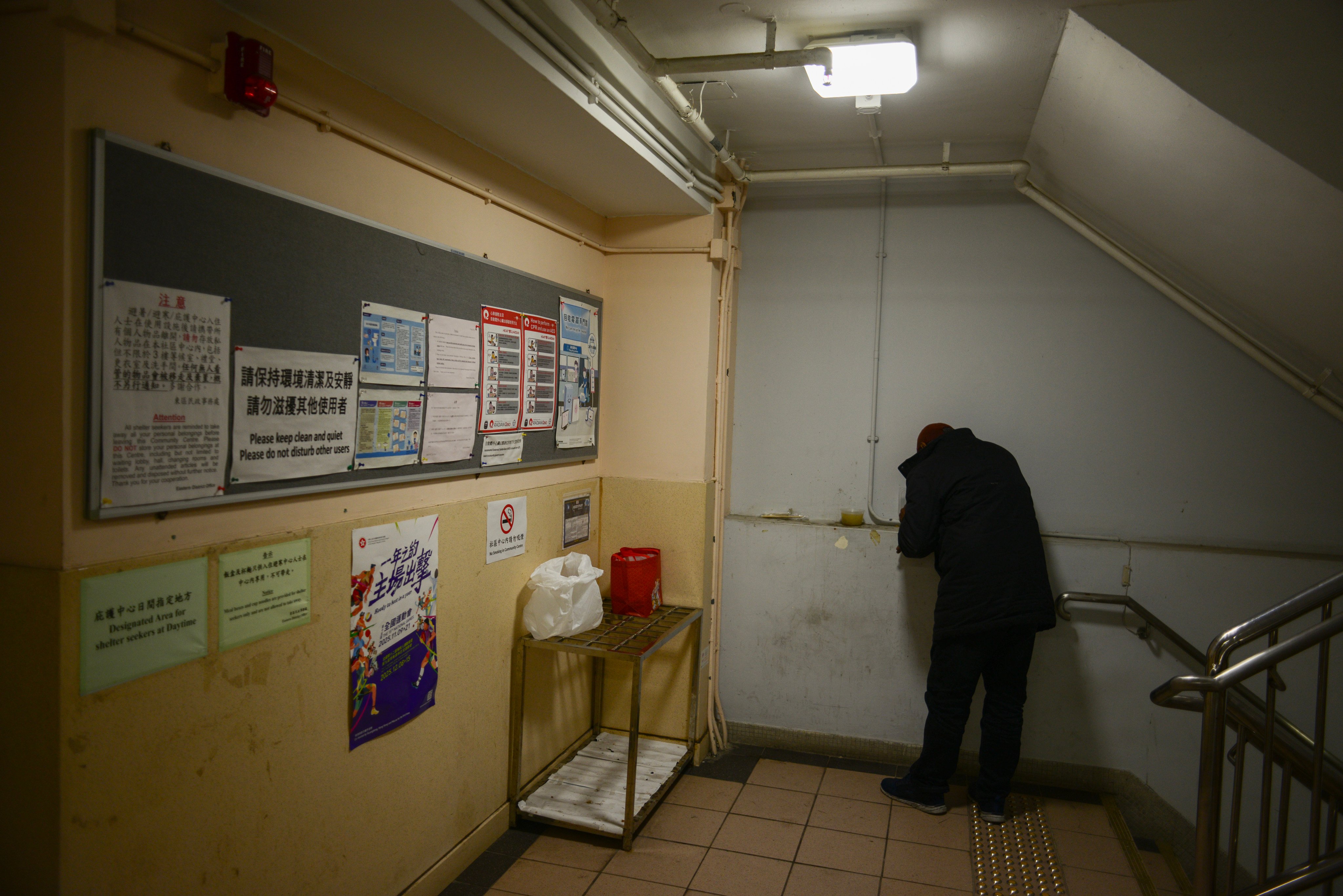 A man eats a free meal outside the Causeway Bay Community Centre. Photo: Antony Dickson
