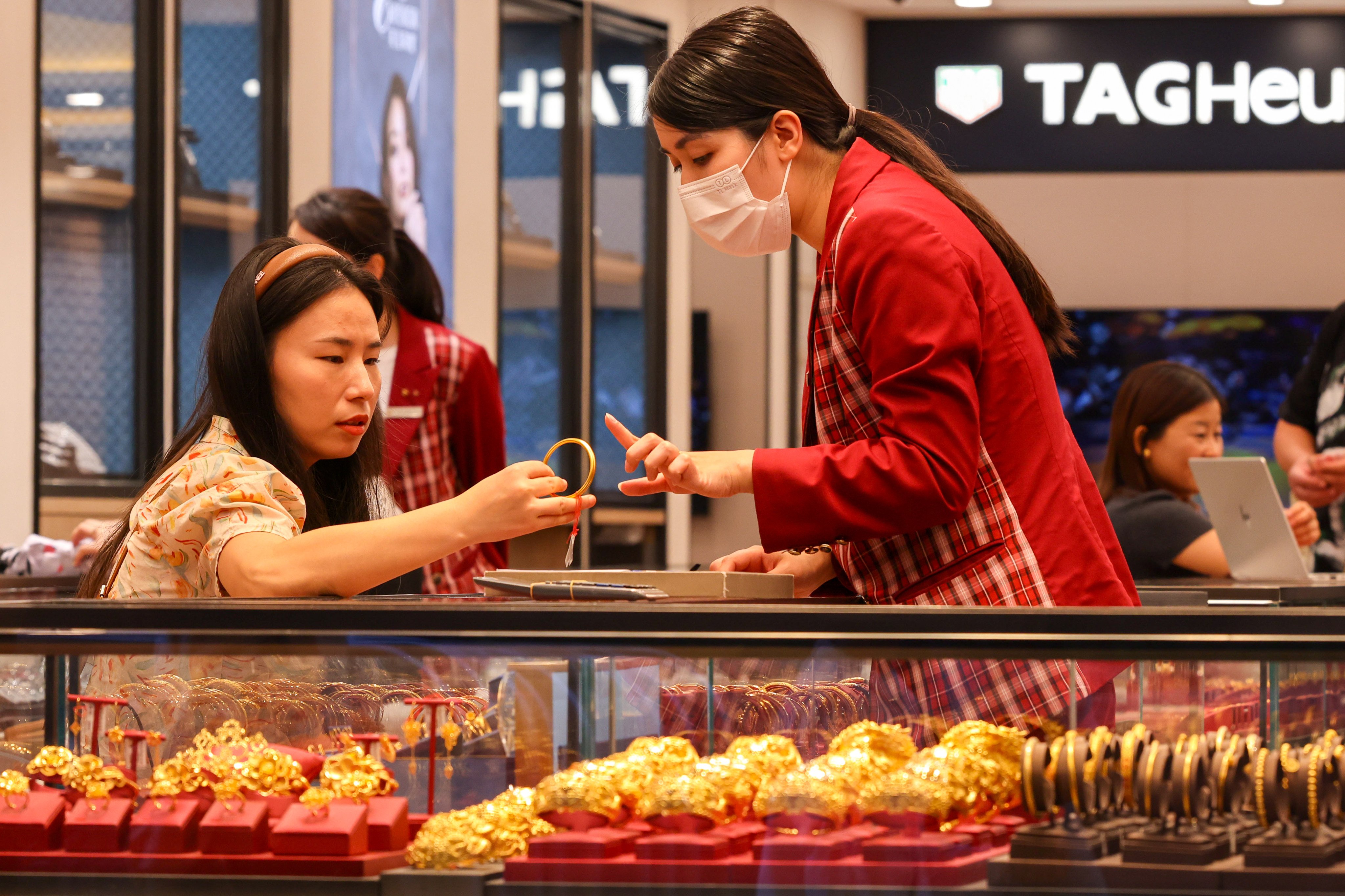 A customer checks out gold jewellery in Hong Kong. Photo: Nora Tam