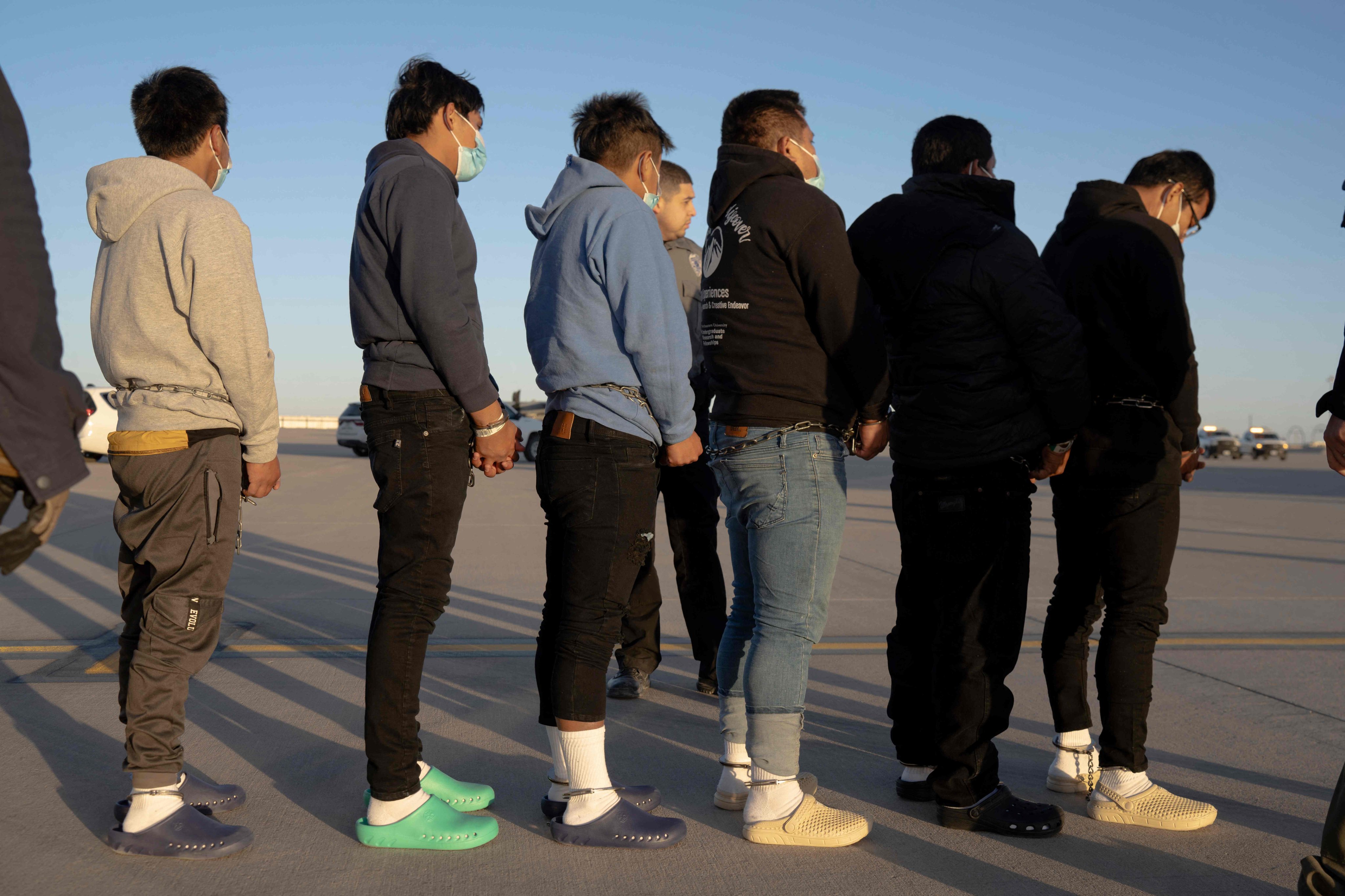 This image released by the Pentagon shows shackled undocumented migrants preparing to board a C-17 Globemaster III assigned to the 60th Air Mobility Wing for a removal flight at Fort Bliss, Texas, on Thursday. Photo: Department of Defence via AFP 