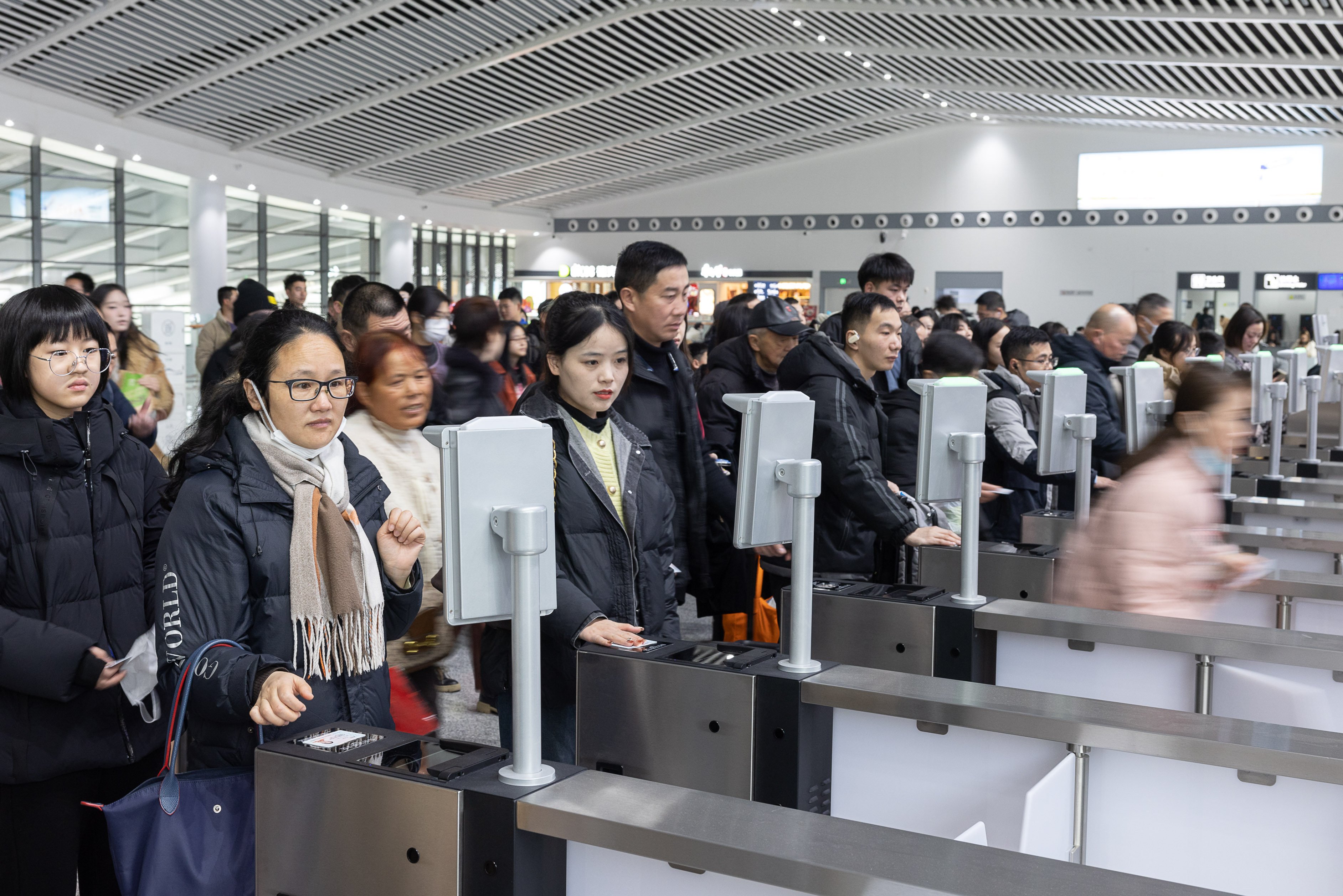 Passengers have their tickets scanned before boarding at the Huzhou East Railway Station in eastern China’s Zhejiang province on Monday.
A record 9 billion inter-regional trips are expected during this year’s 40-day Spring Festival travel rush. Photo: Xinhua