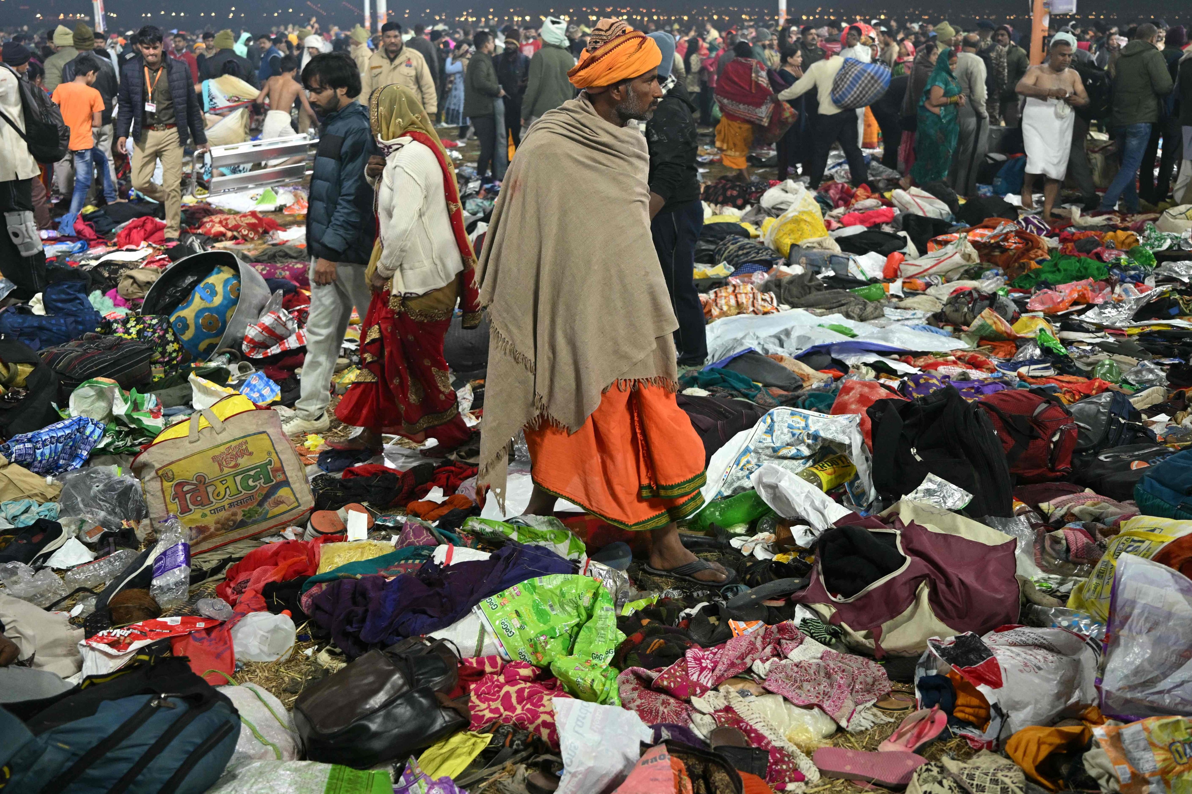 Pilgrims look for their belongings at the site of a stampede amid the ongoing Kumbh Mela festival in Prayagraj on Wednesday. Photo: AFP