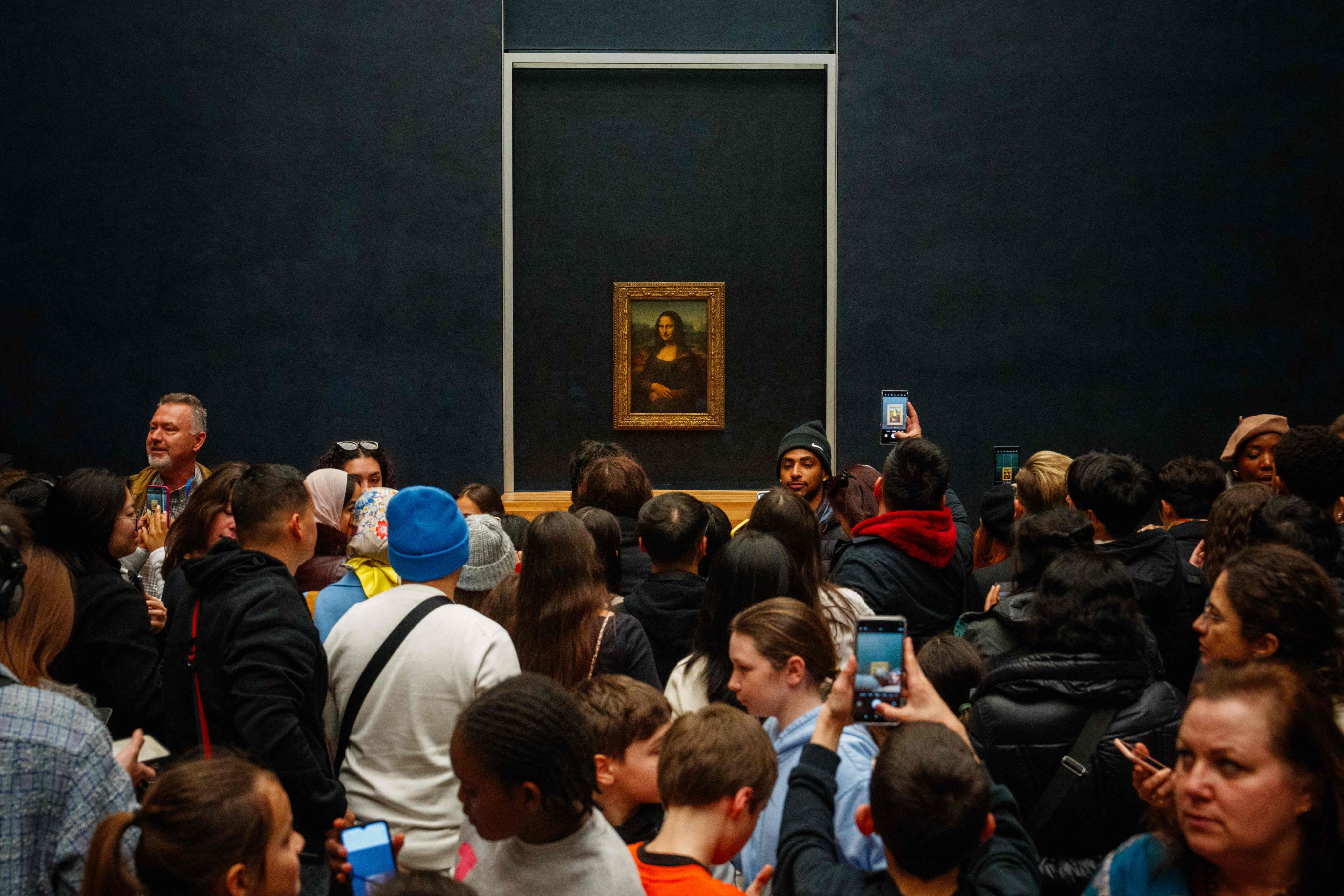 Visitors take pictures of the “Mona Lisa” by Italian artist Leonardo da Vinci at the Louvre in Paris on Thursday. Photo: AFP