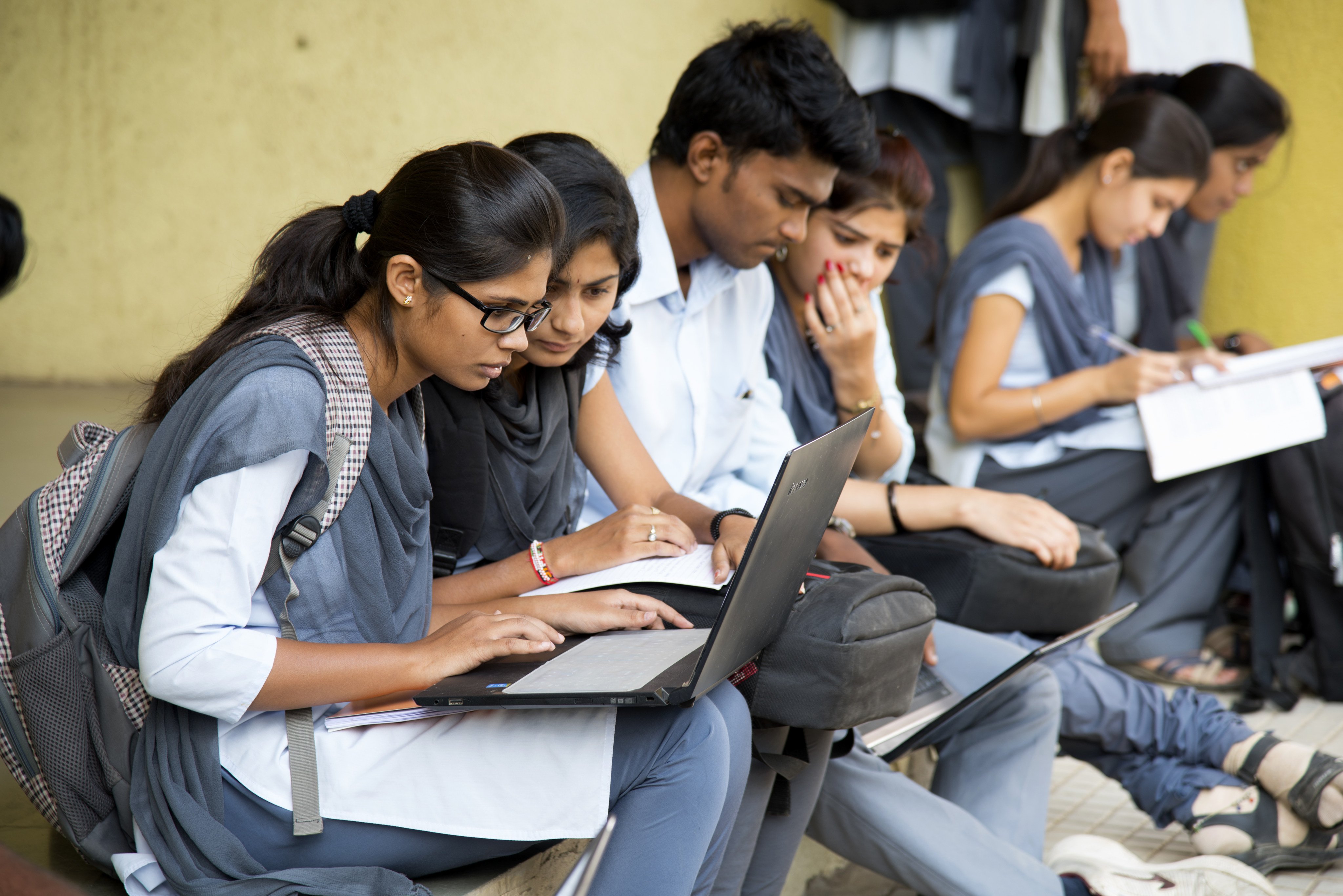 Students working on their laptop on campus in India. Educators have acknowledged that there is a digital divide in the country. Photo: Shutterstock