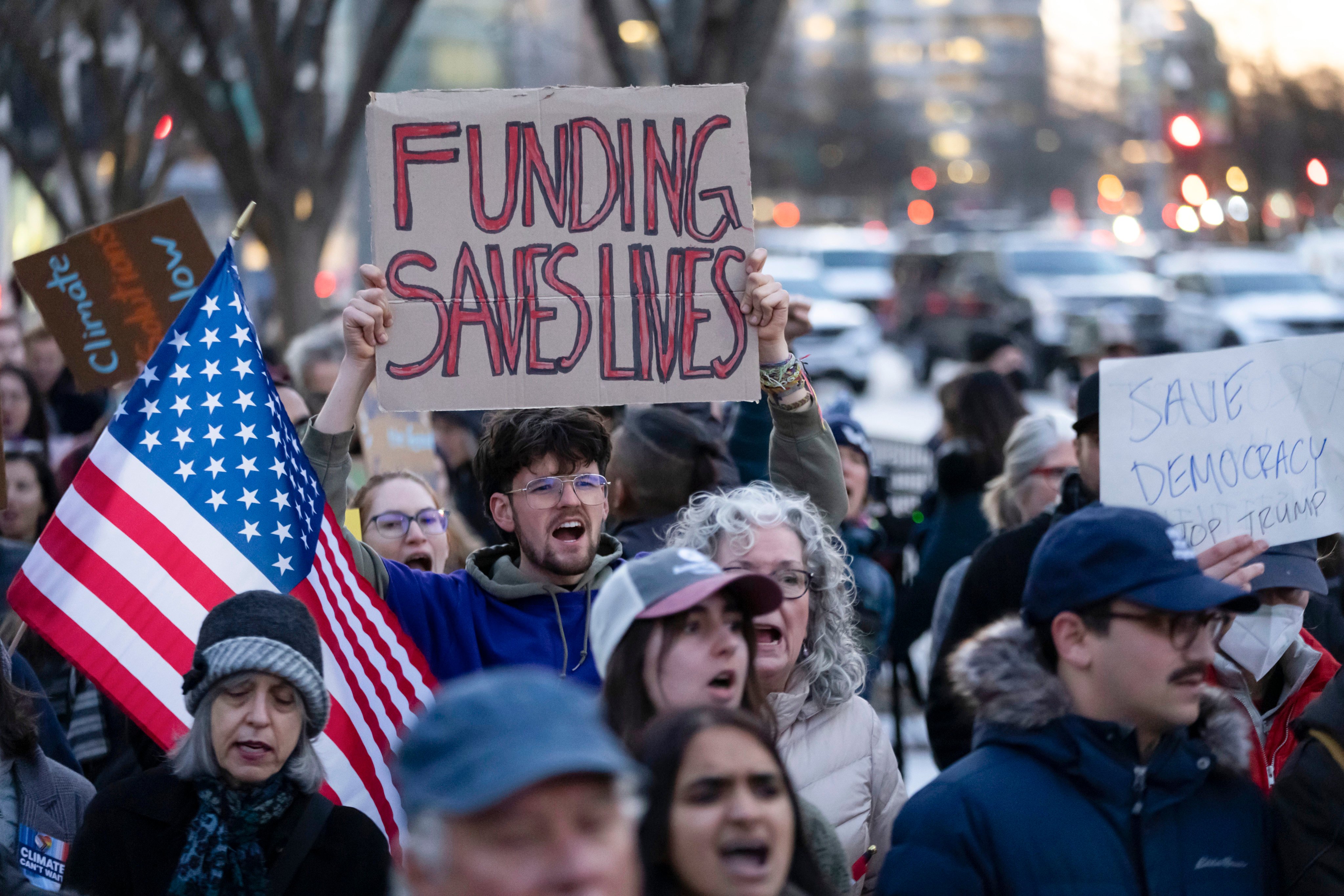 People protest against a funding freeze of federal grants and loans  near the White House on Tuesday. Photo: AP