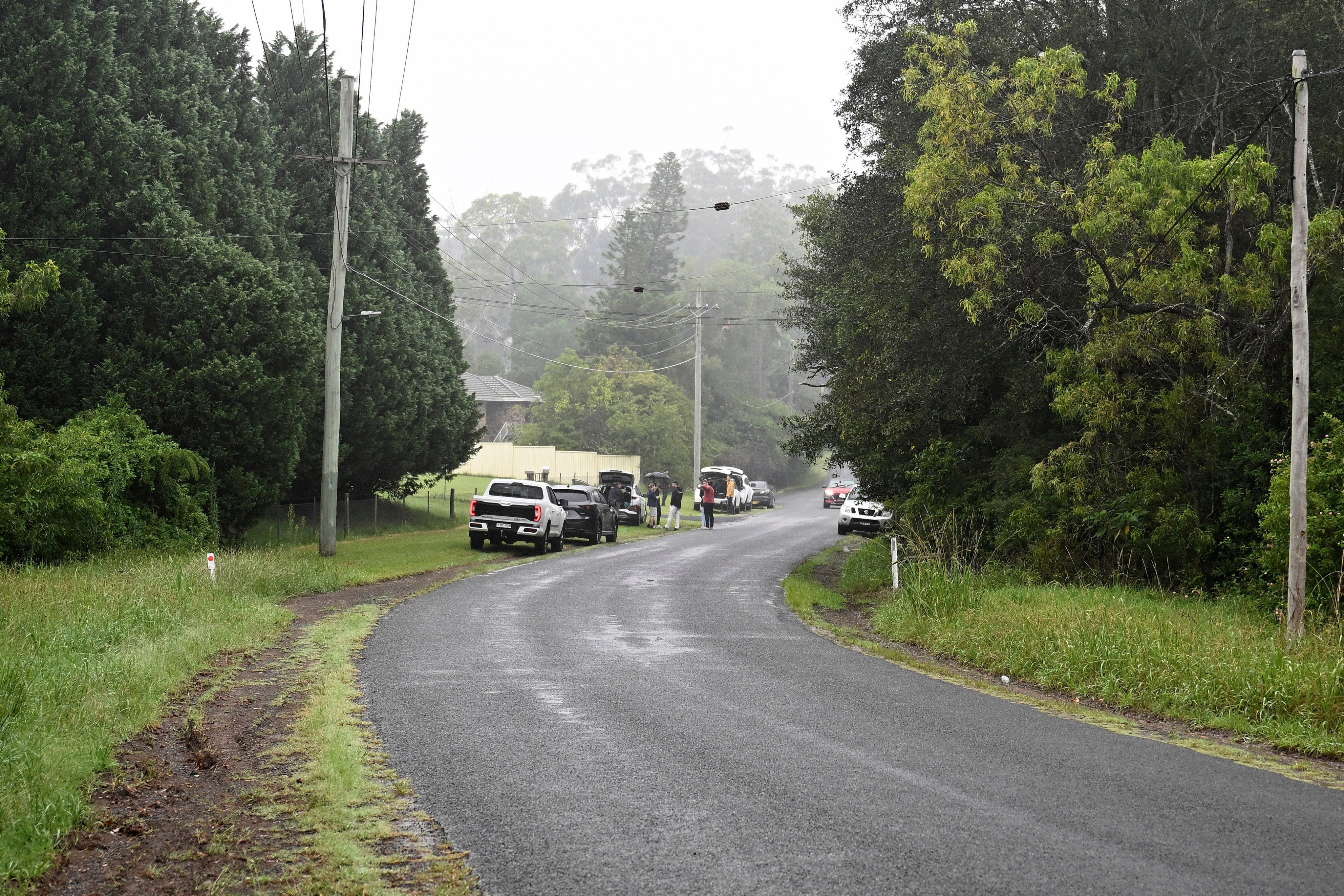 People and vehicles near where a caravan containing explosives was found on the side of a road in the Sydney suburb of Dural. Photo: Bianca De Marchi/AAP Image via AP