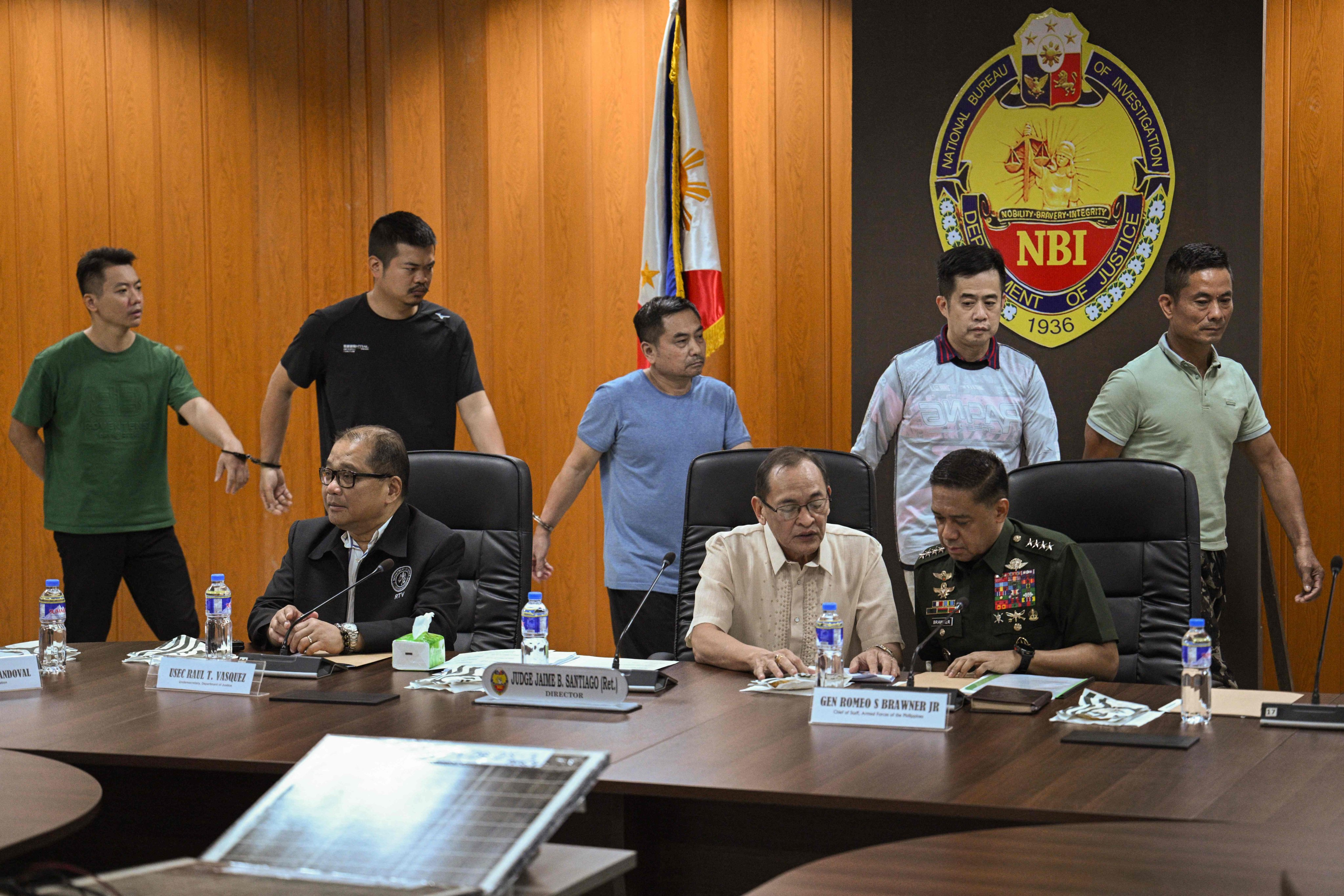 Philippine military chief General Romeo Brawner (front right), National Bureau of Investigation chief Jaime Santiago (front centre) and undersecretary of the Department of Justice Raul Vasquez (front left) announce the arrest of five alleged Chinese spies. Photo: AFP