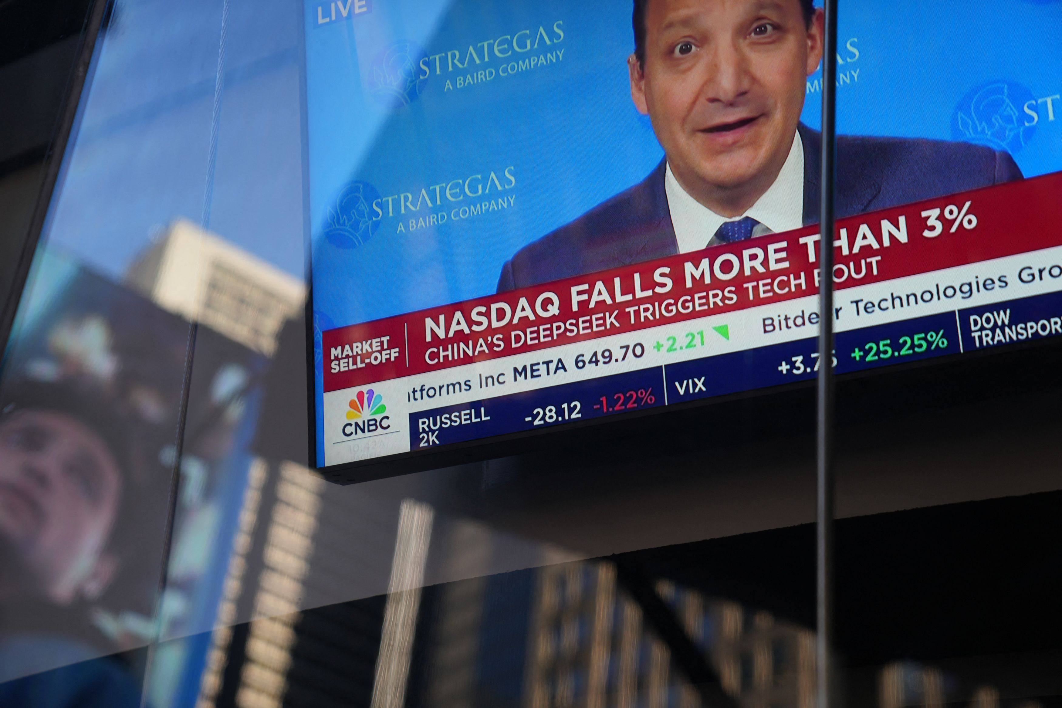 Television graphics are seen in the window of Nasdaq headquarters in Times Square, US, as the Nasdaq fell nearly 4 per cent on the morning of January 27, upon news that a cheaper Chinese generative AI programme DeepSeek can outperform its big-name rivals in the US. Photo: AFP