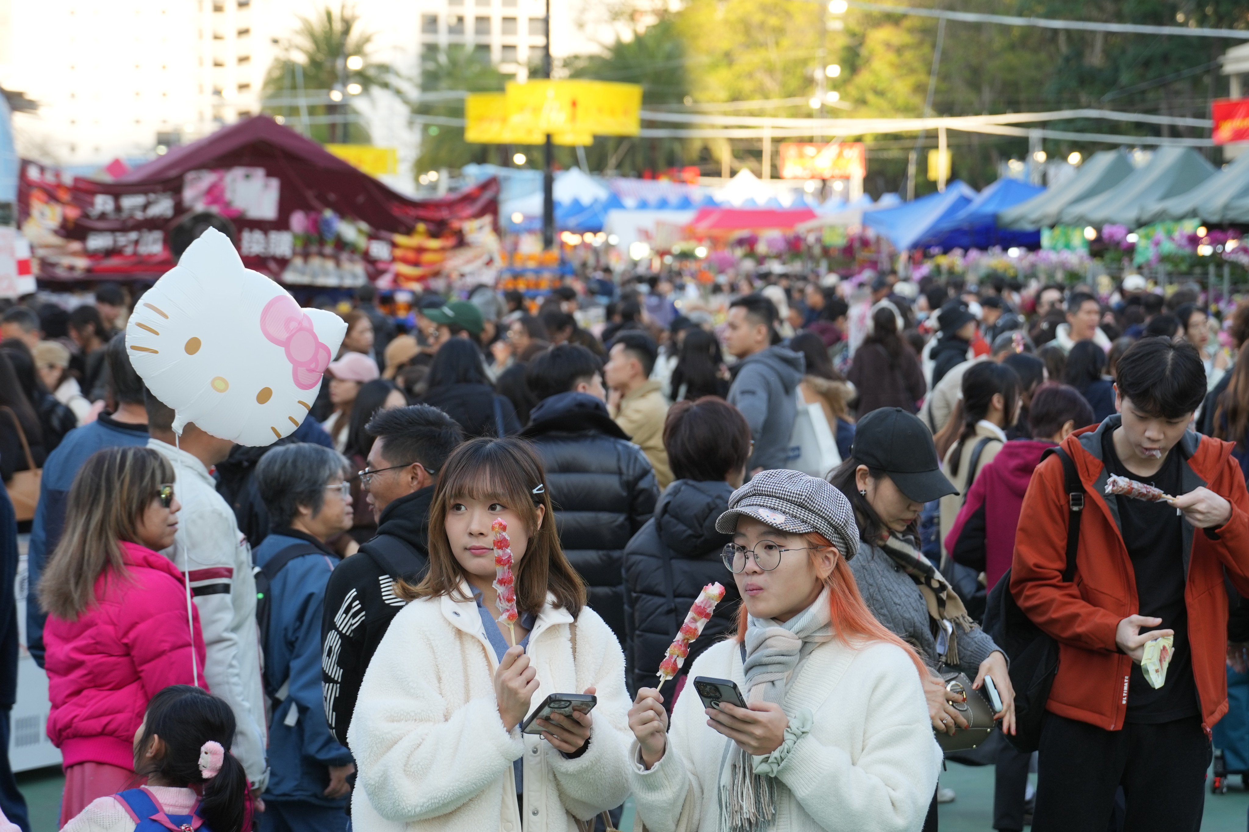 People enjoy a snack at the Lunar New Year Fair at Victoria Park in Causeway Bay on January 27.   Photo: Sam Tsang