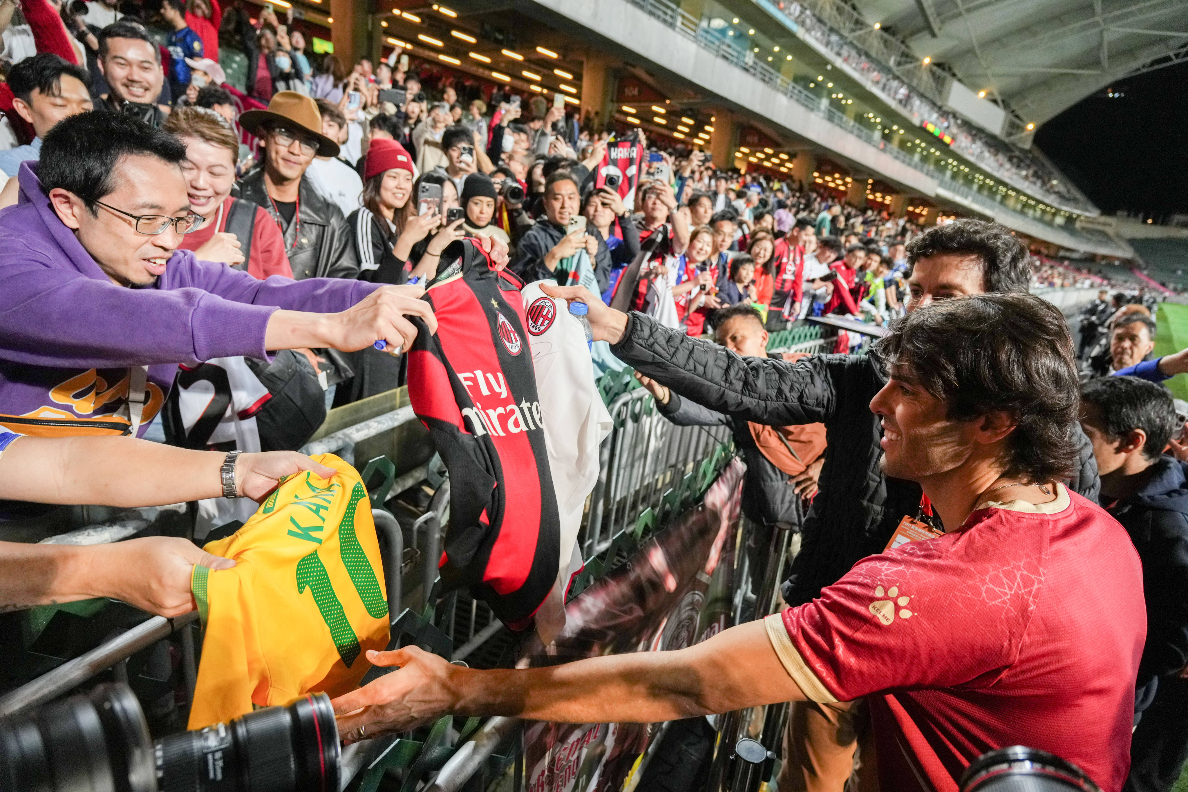 Brazilian football star Kaka signs autographs for fans before the friendly match. Photo: Eugene Lee