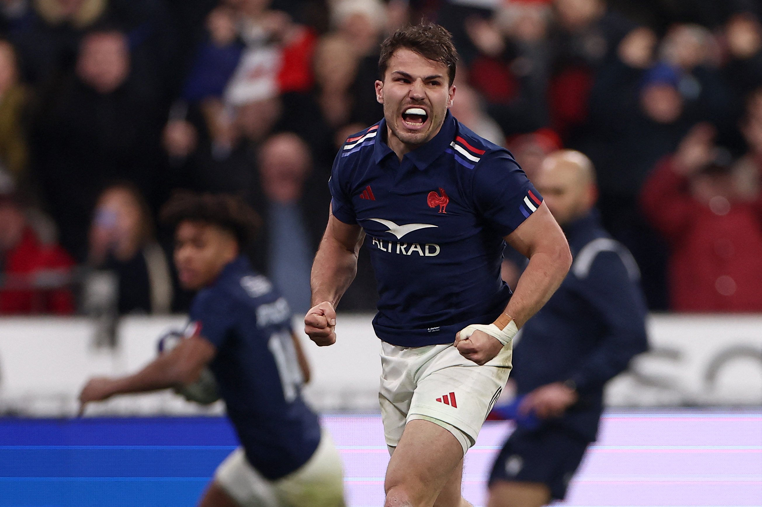 France’s scrum-half and captain Antoine Dupont celebrates France’s third try against Wales at the Stade de France. Photo: AFP