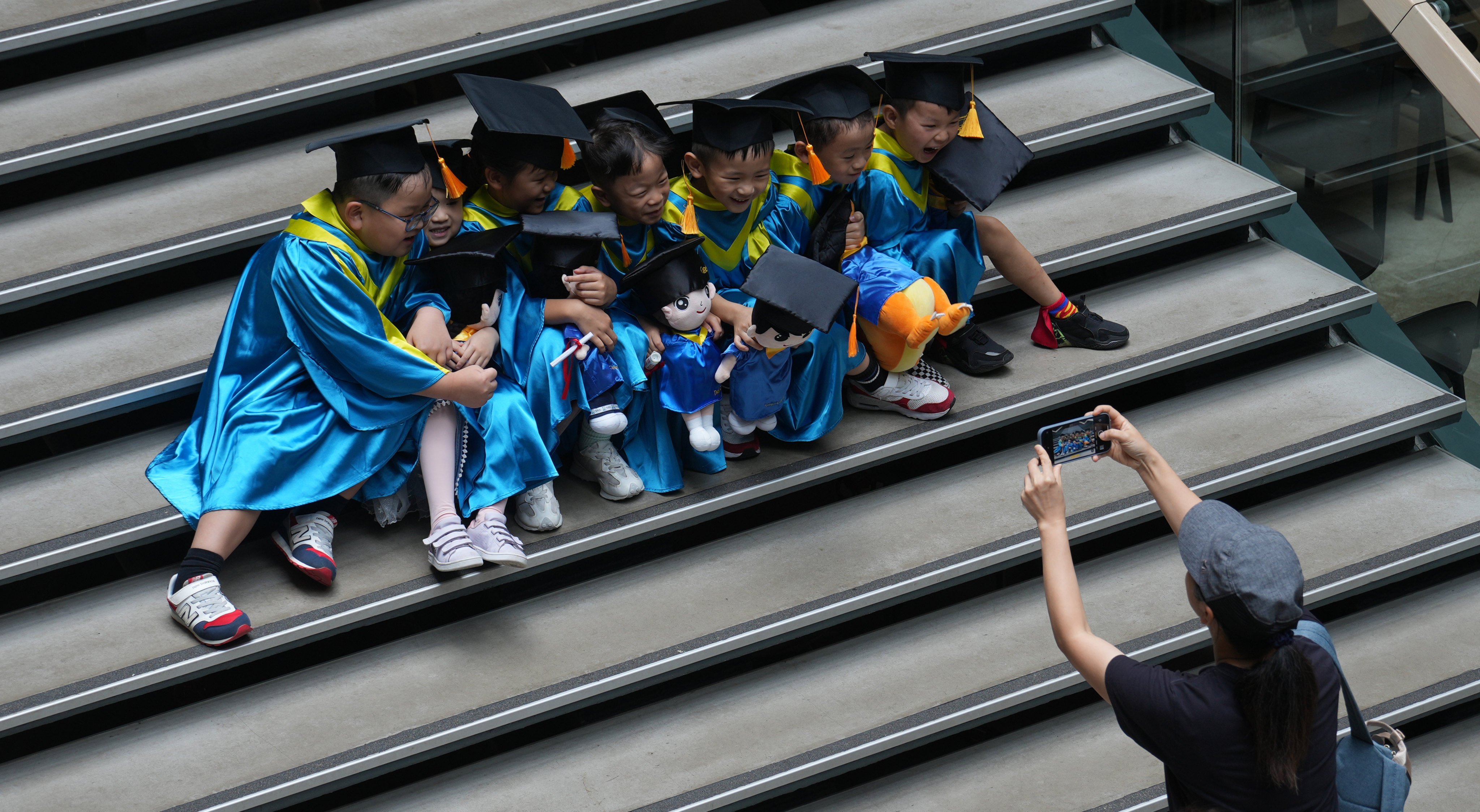 Kindergarten children pose for pictures at The Mills in Tsuen Wan.  Photo: Sam Tsang