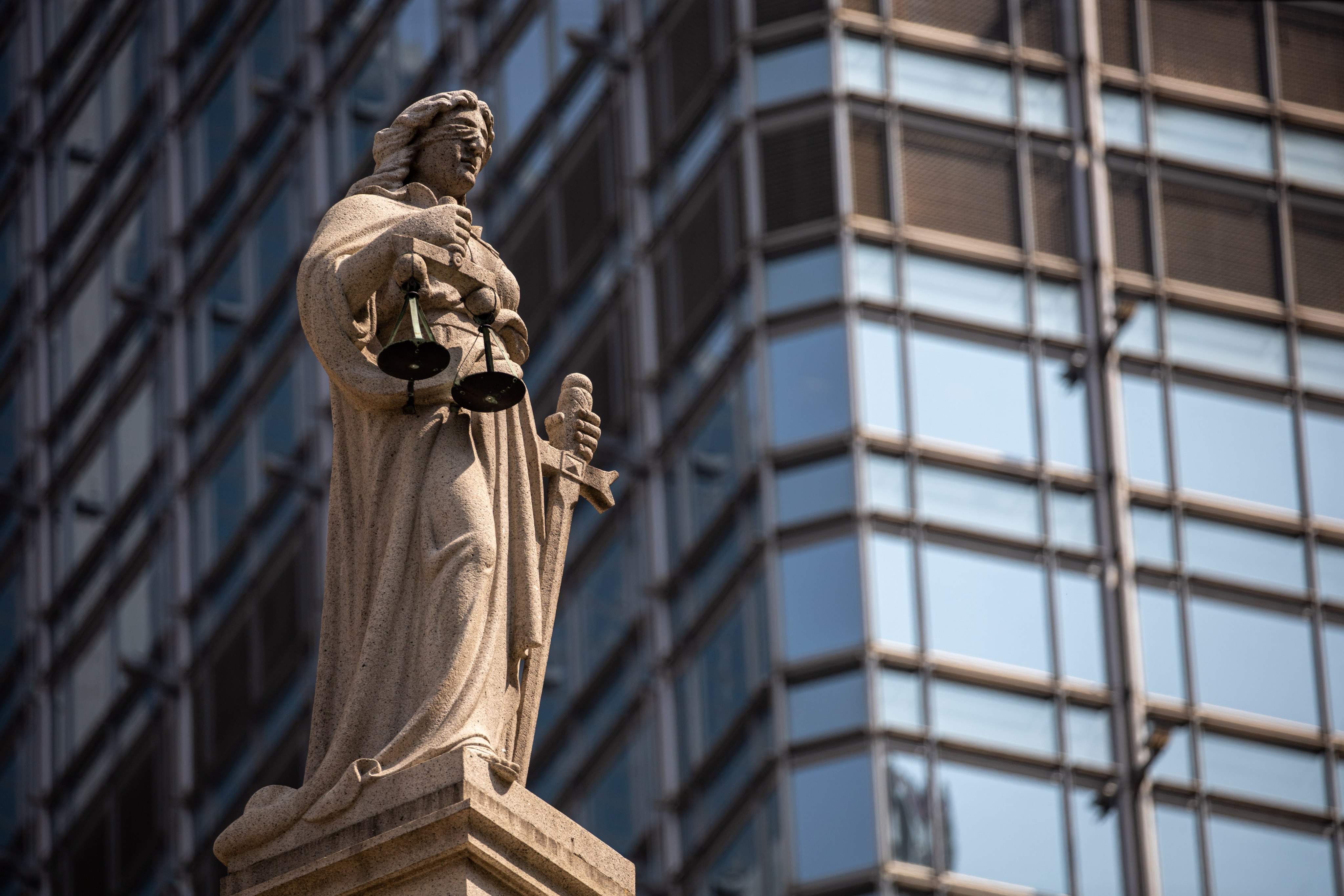 A statue of Lady Justice sits on top of the Court of Final Appeal building in Hong Kong’s Central district. Photo: EPA-EFE/JEROME FAVRE