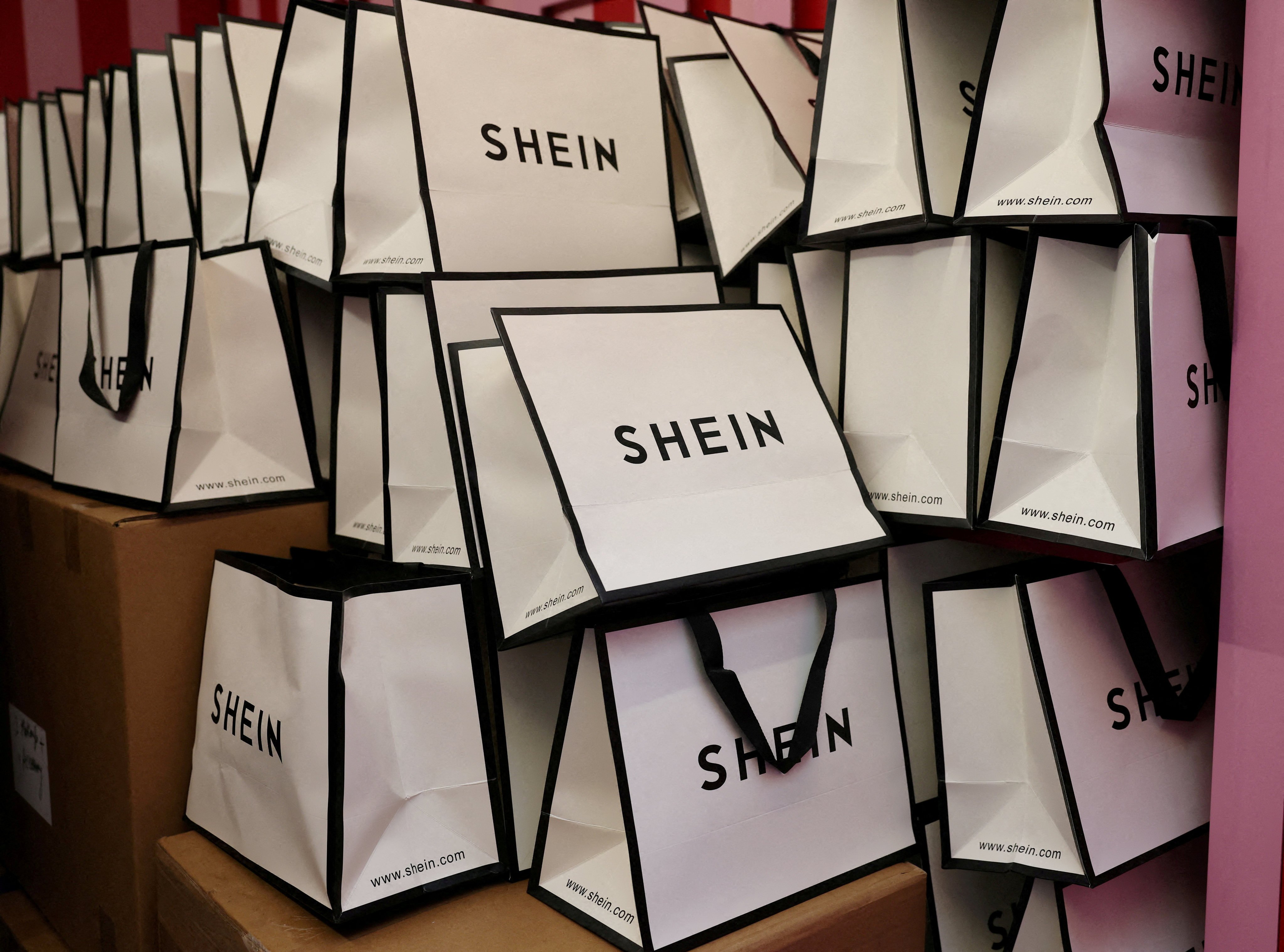 A company logo for fashion brand Shein is seen on a pile of gift bags. Photo: Reuters