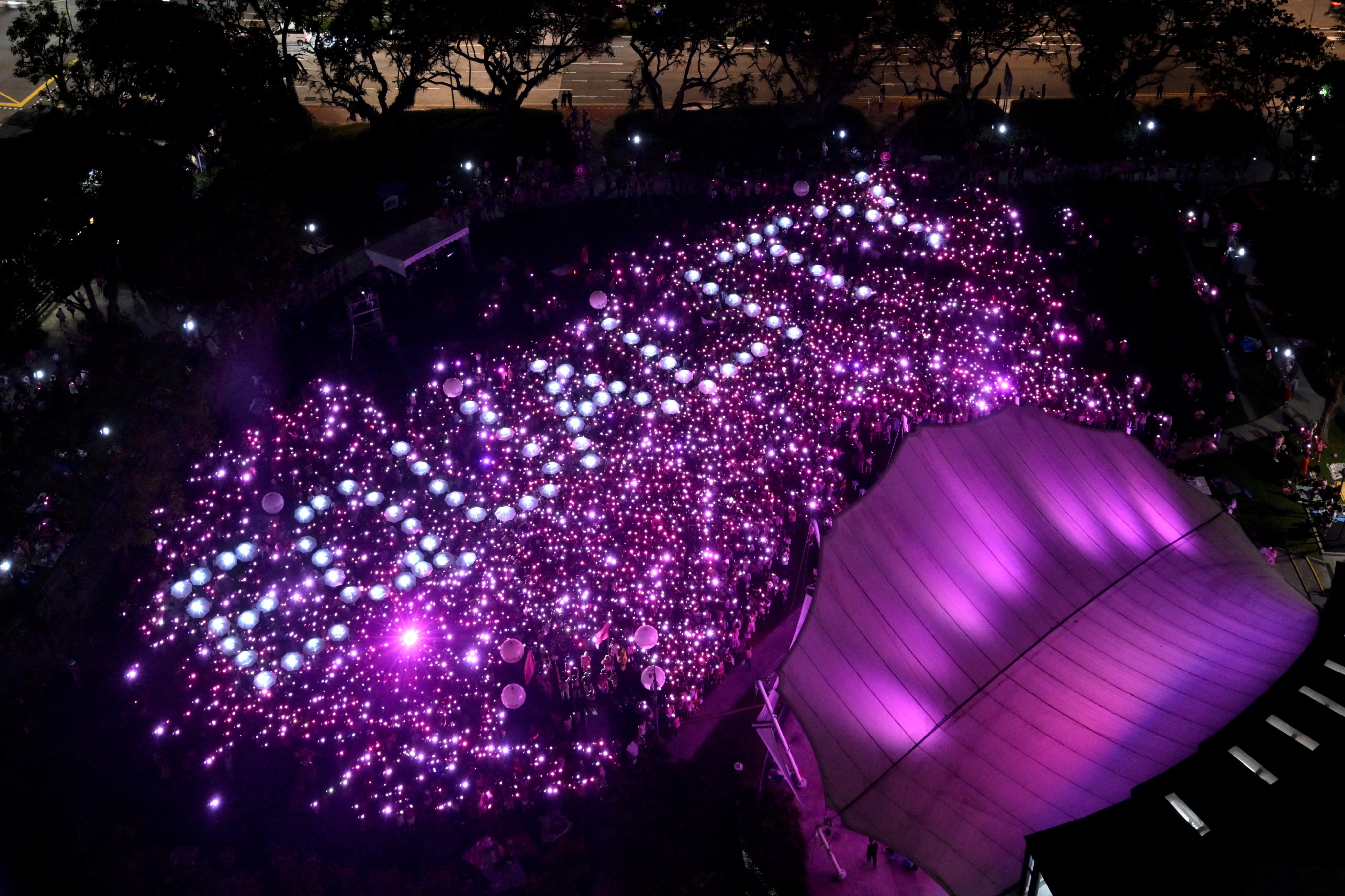 Attendees at the 2024 Pink Dot rally in Singapore, an annual event in support of the LGBTQ community, form the word ‘equality’ with light torches. Photo: Reuters