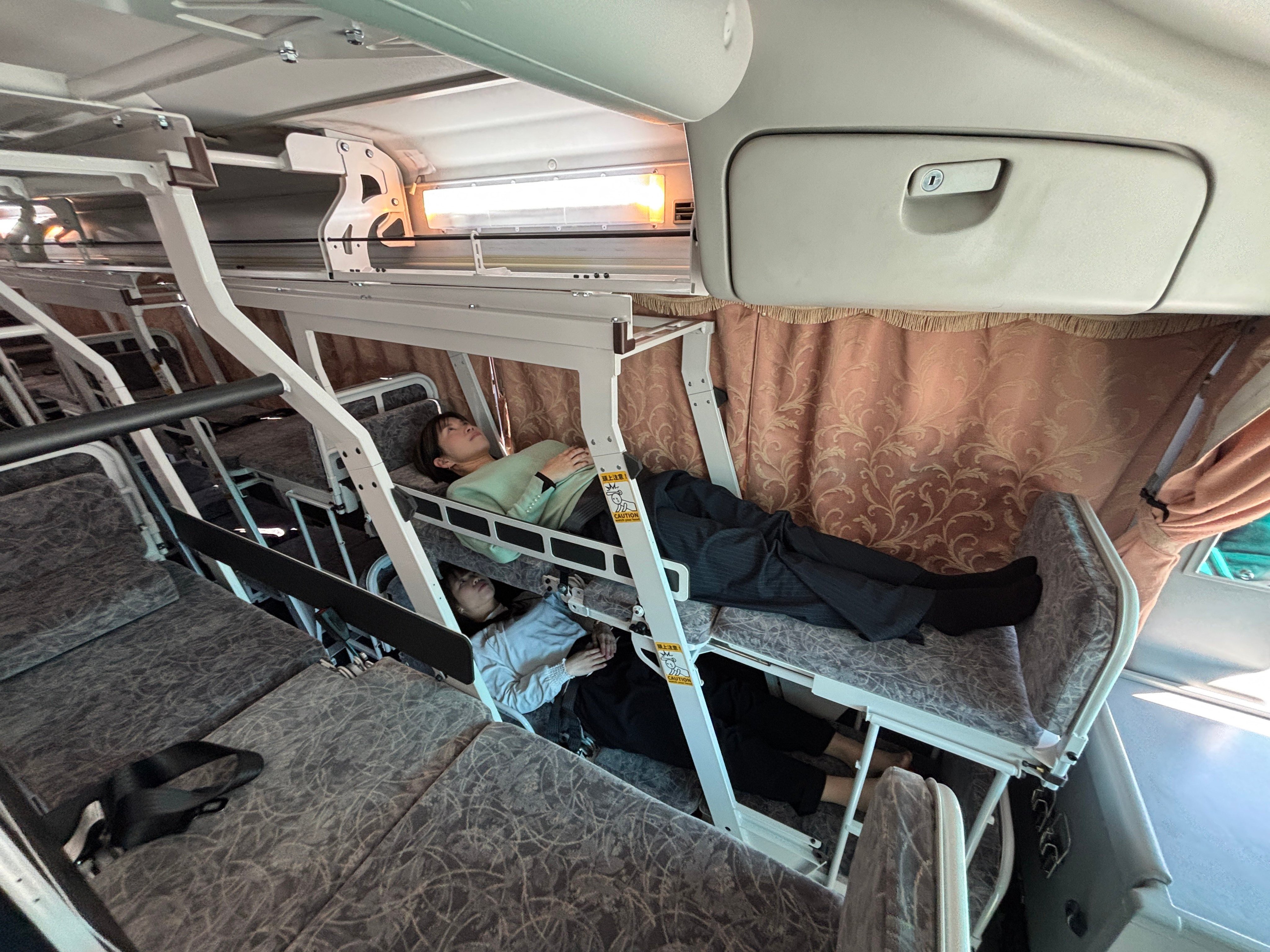 Two women try out the Sommeil Profond, an overnight bus service between Tokyo and Kochi which will begin operations in March. Photo: Handout